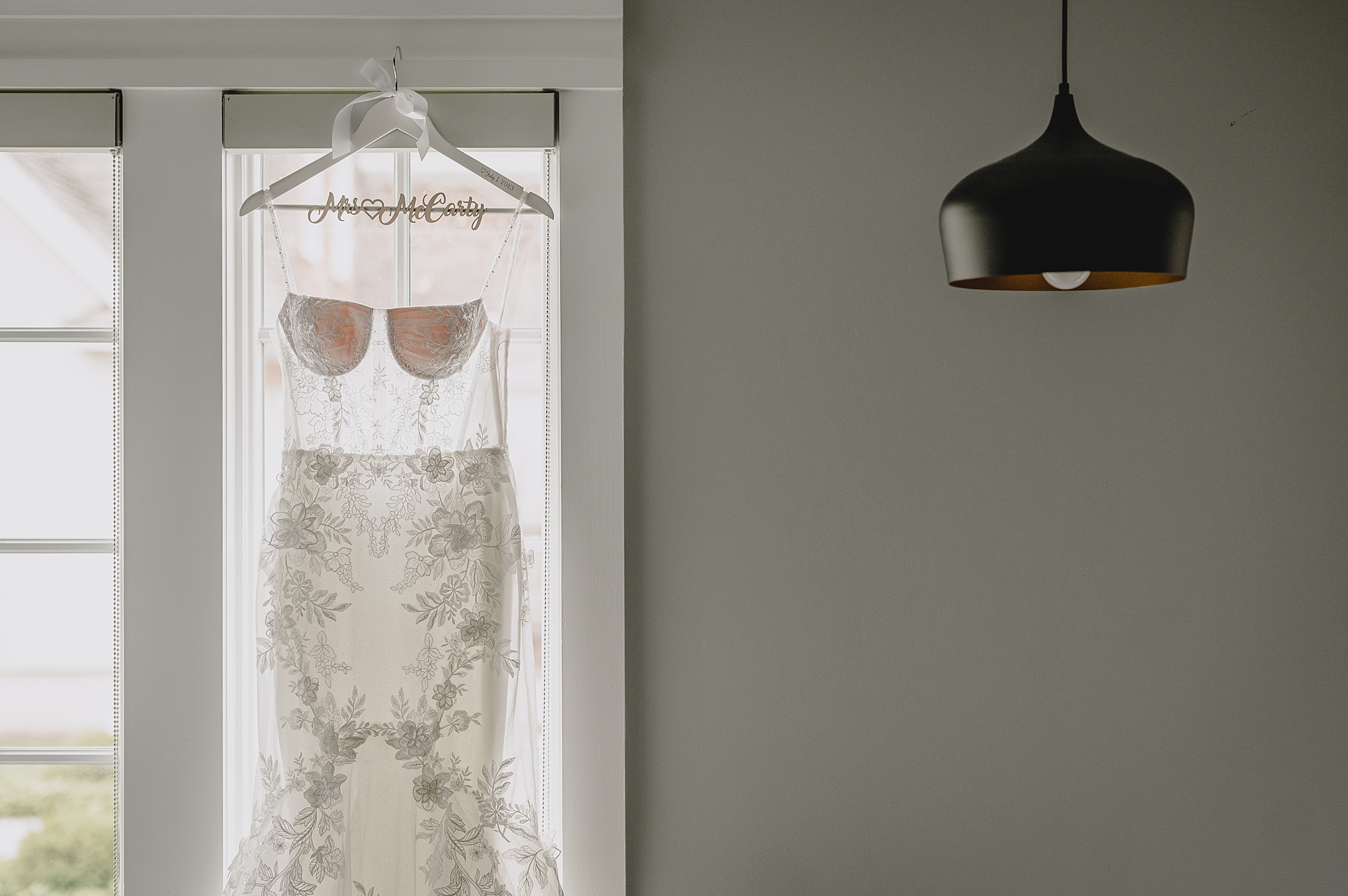 wedding dress hangs in window of the Ryland Inn