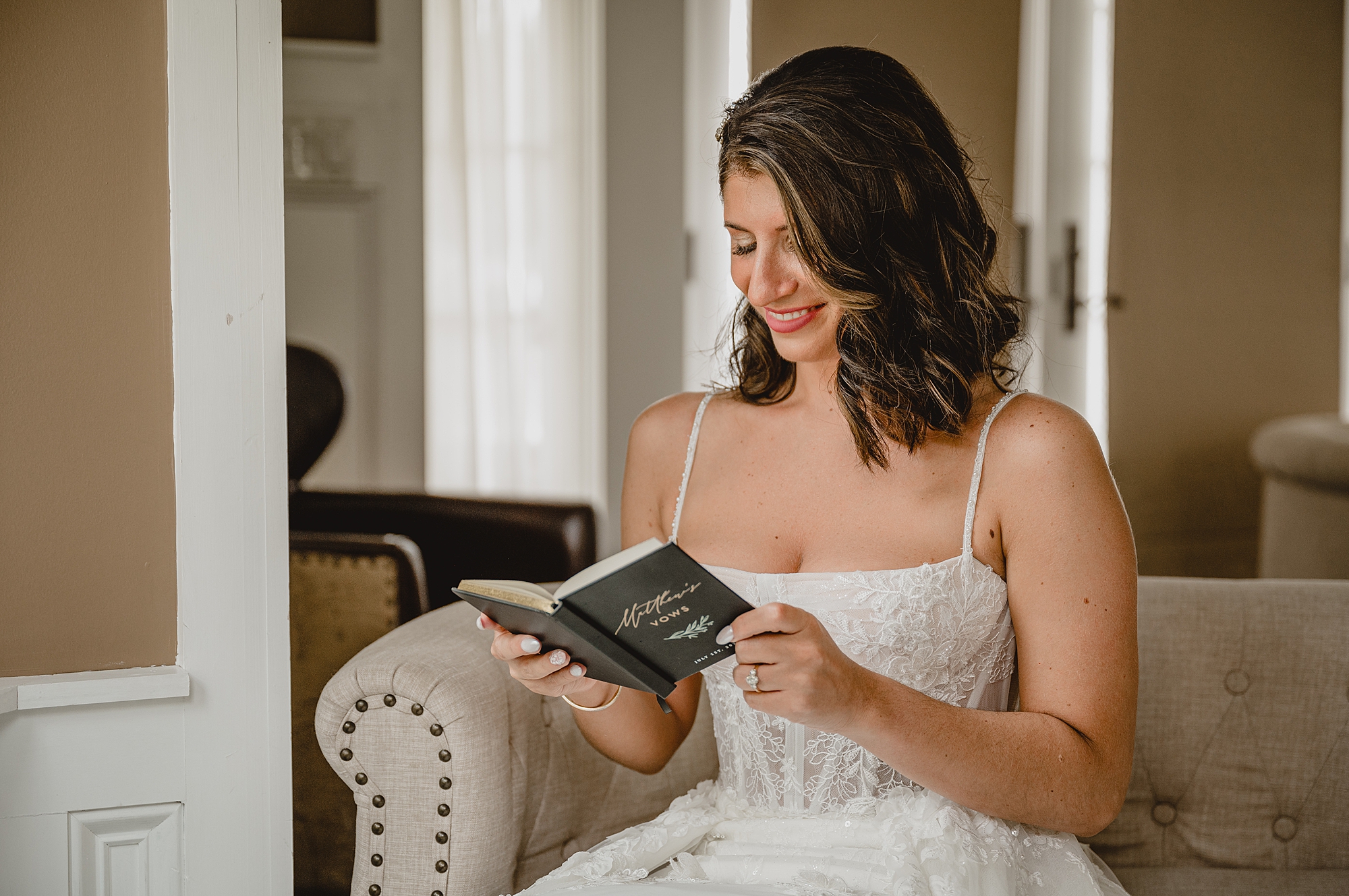 bride opens up vow booklet with note from groom