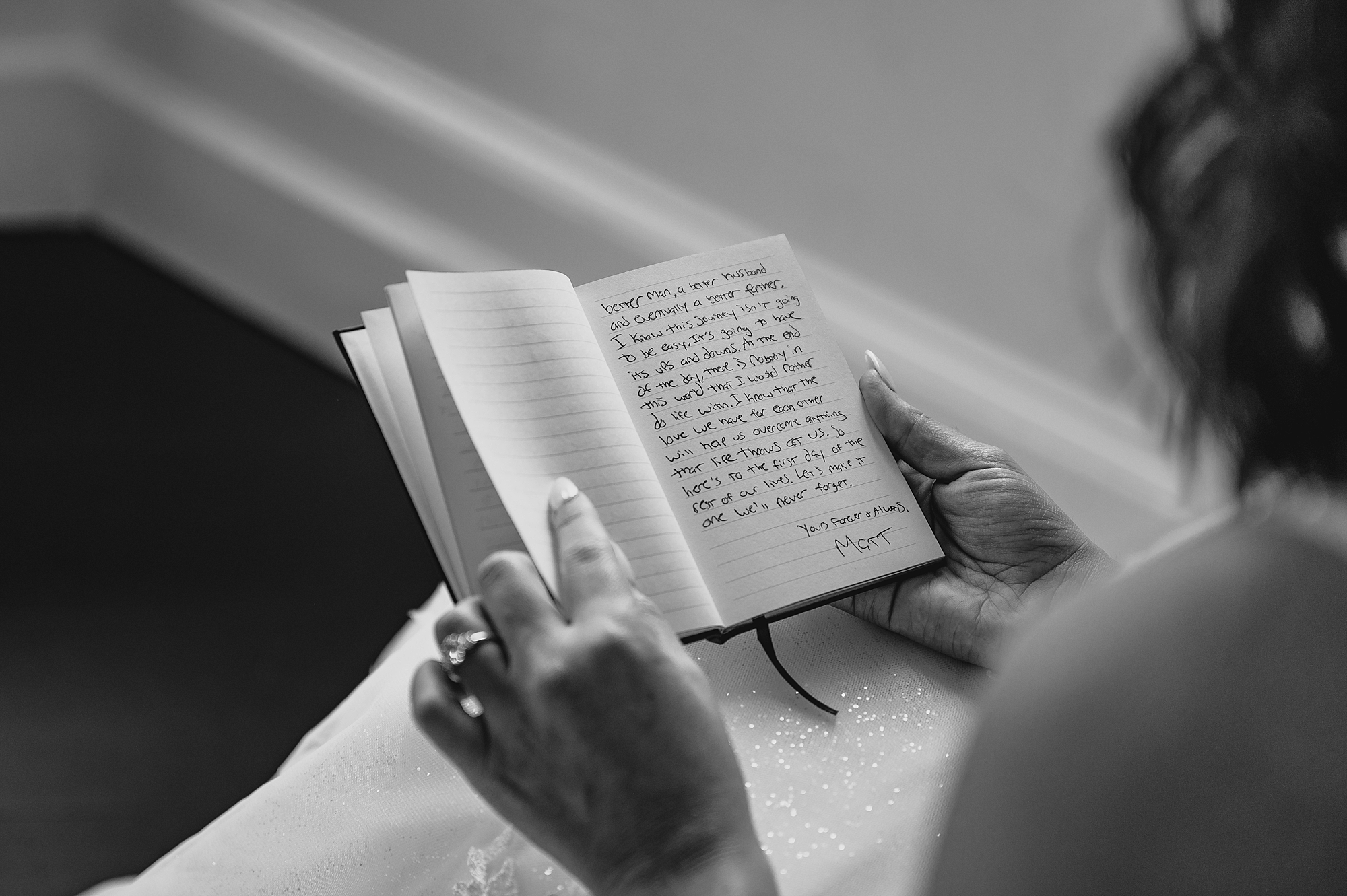 handwritten vows in book for bride to read over her shoulder