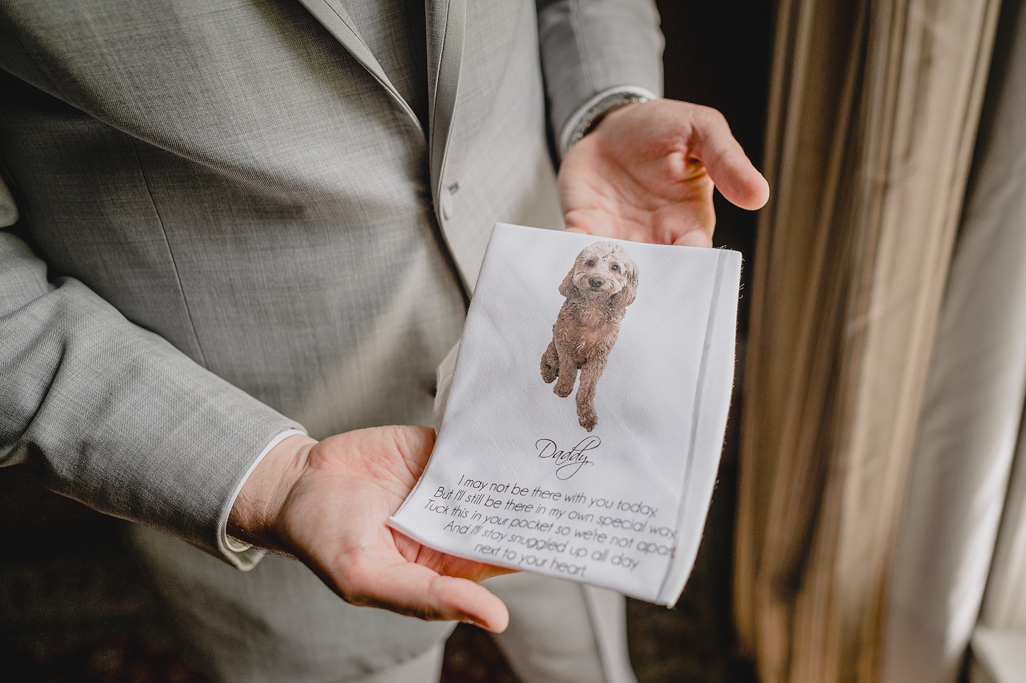 groom holds custom handkerchief with dog on it