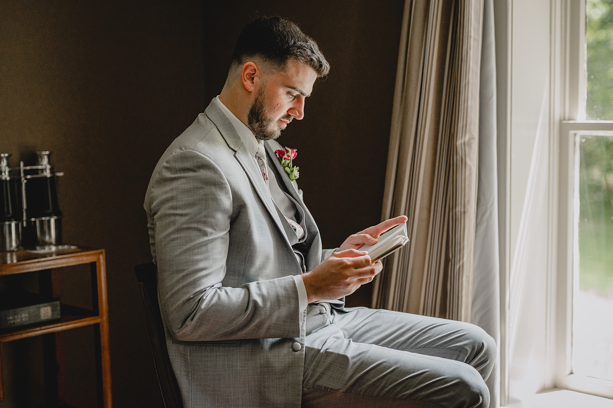 groom reads vow booklet from bride on wedding morning