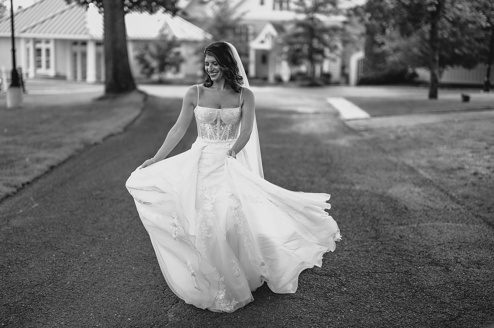 bride in wedding gown with corset bodice twirls dress