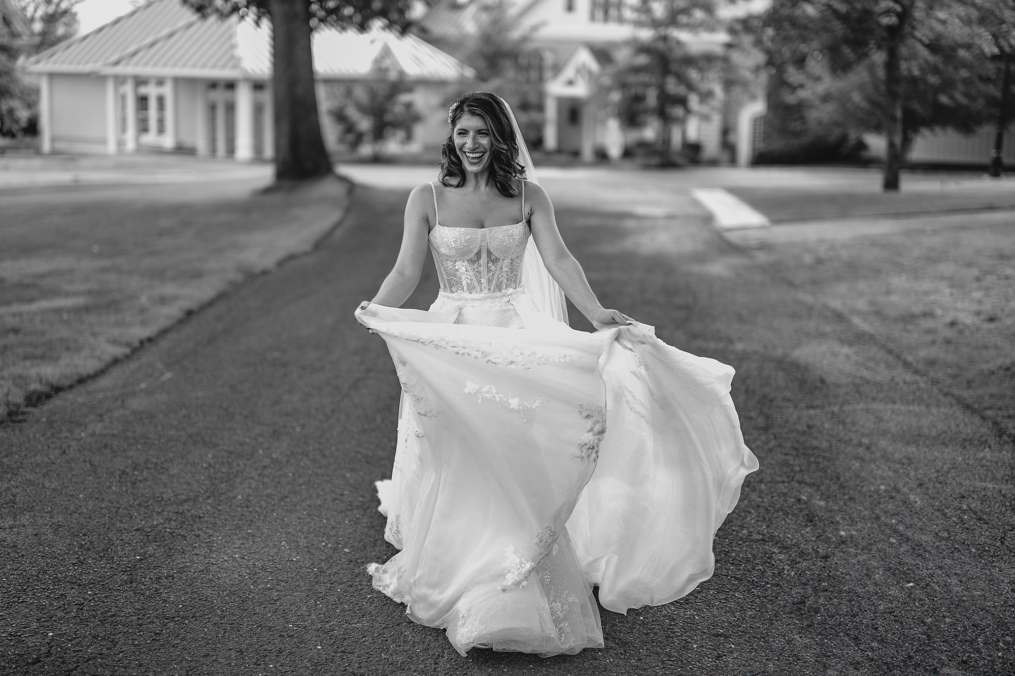 bride in wedding dress twirls around on driveway at the Ryland Inn
