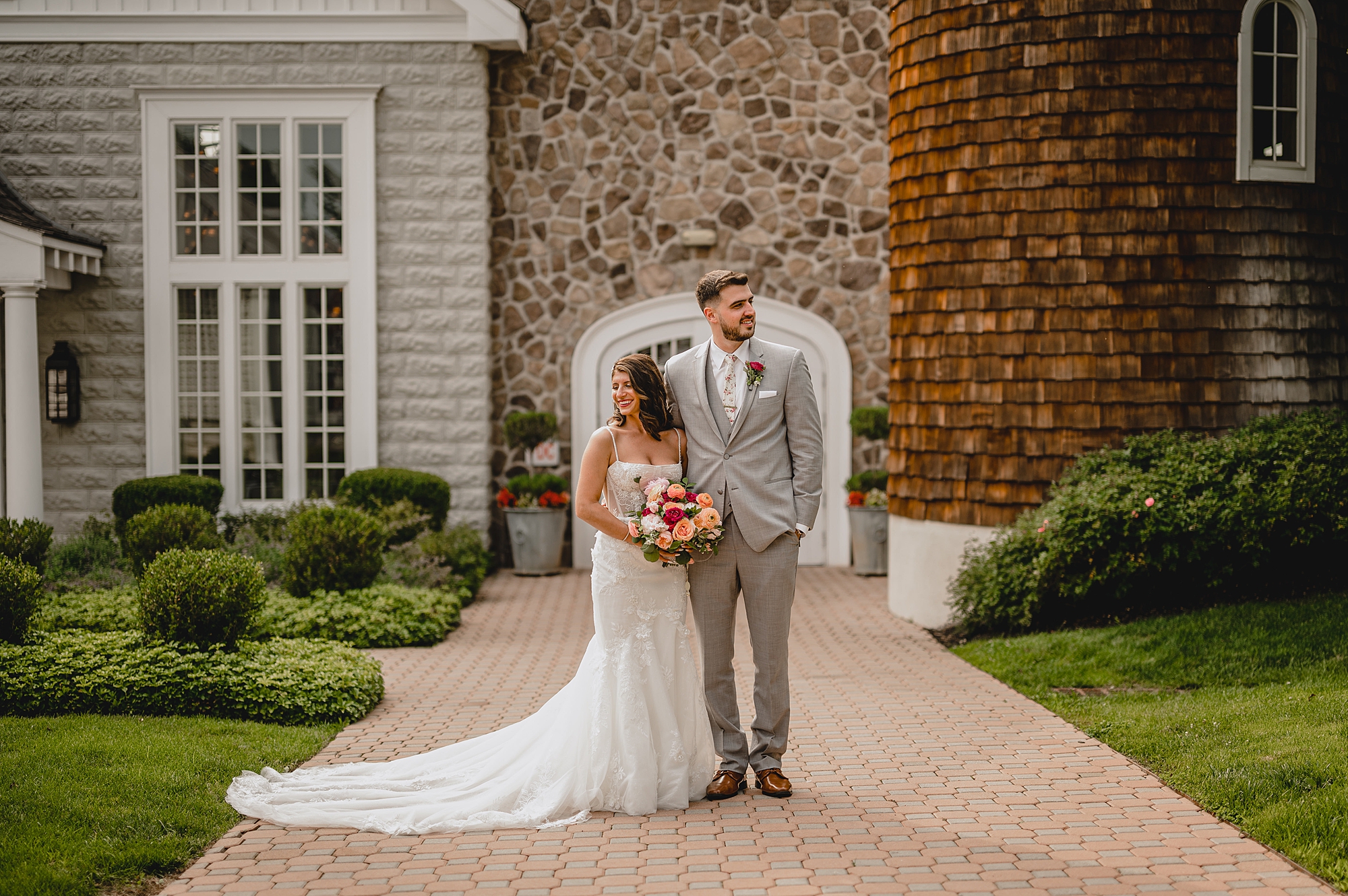 bride and groom hold hands looking apart at the Ryland Inn