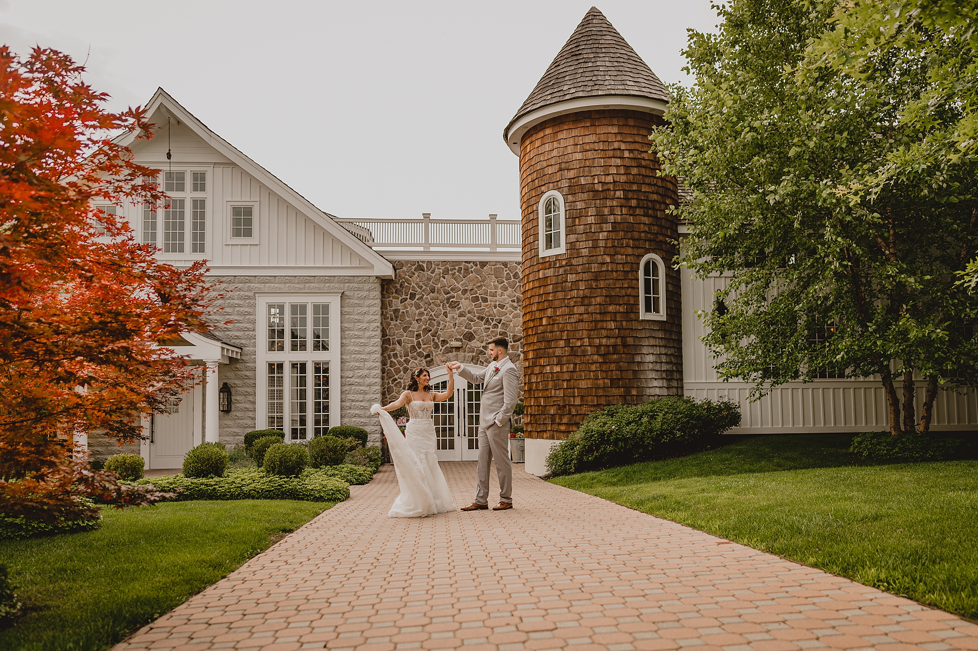 groom twirls bride outside the Ryland Inn