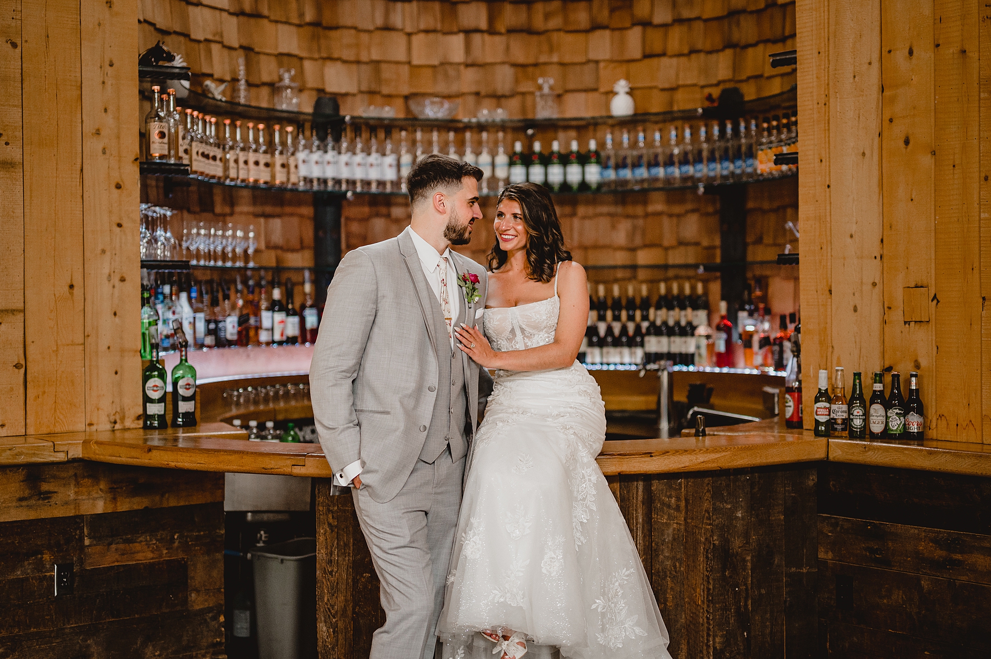 bride and groom sit at the bar at the Ryland Inn