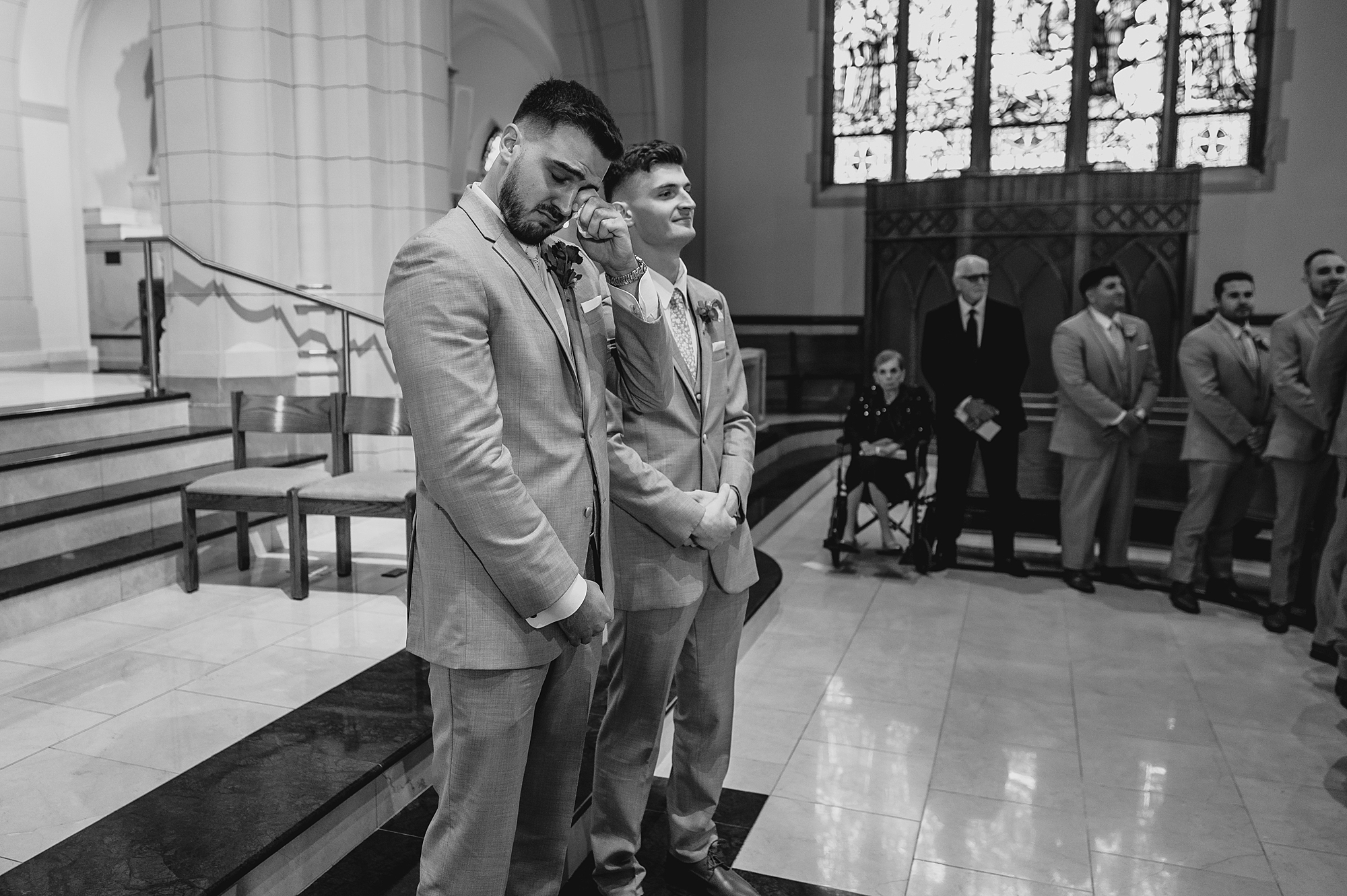 groom wipes away tear during traditional church ceremony in New Jersey