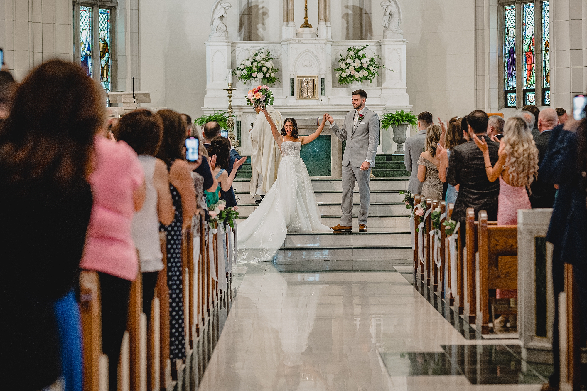 bride cheers after traditional church ceremony in New Jersey