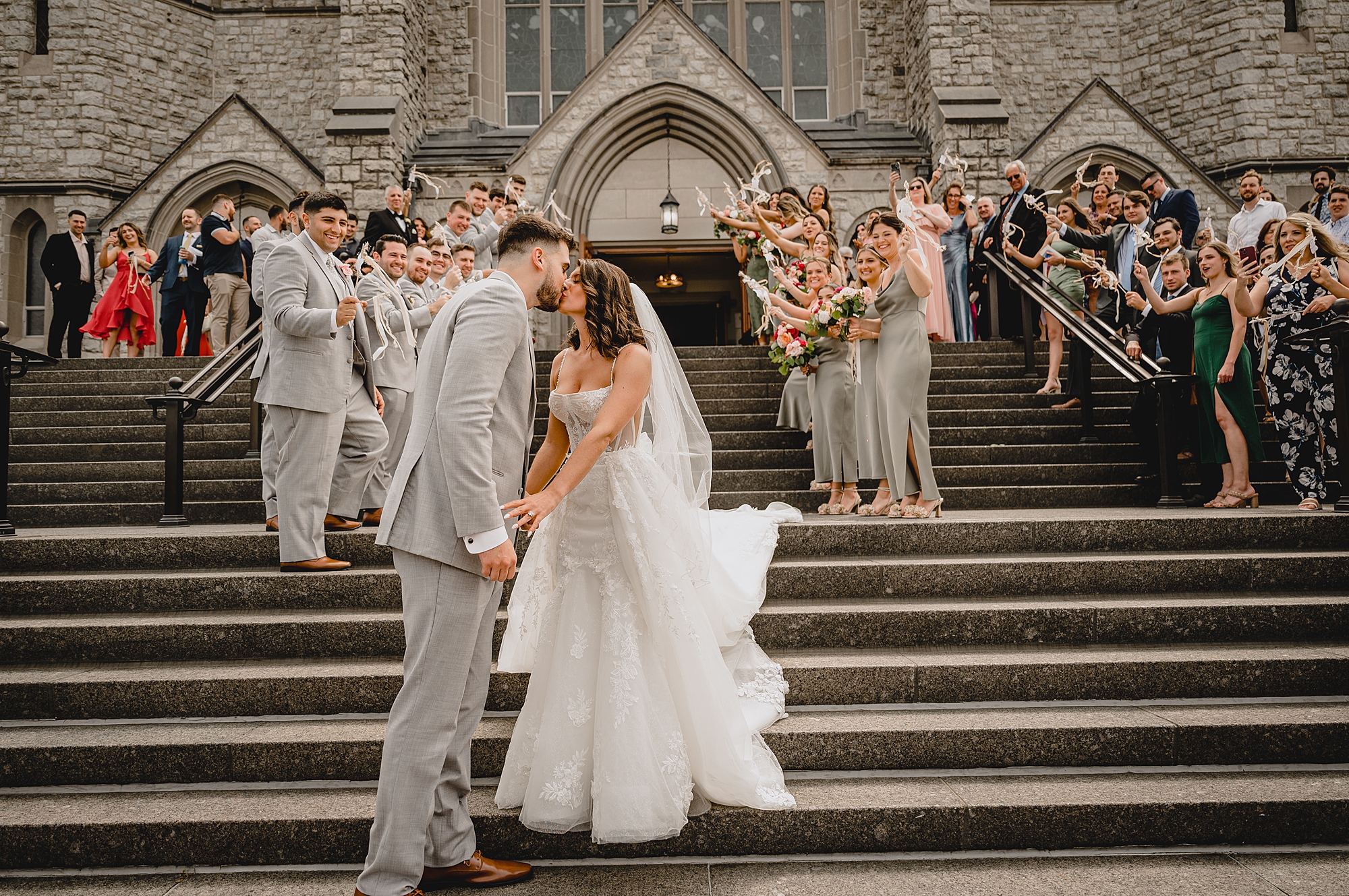 newlyweds kiss on steps leaving church wedding day