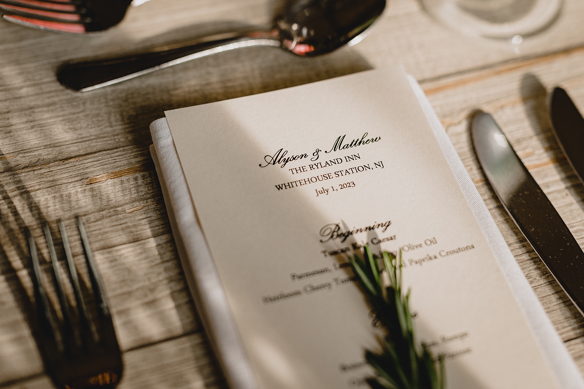 menu card with sprigs of herbs on top