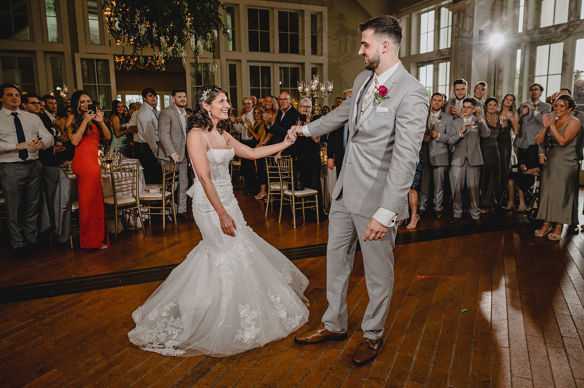 groom twirls bride out during first dance
