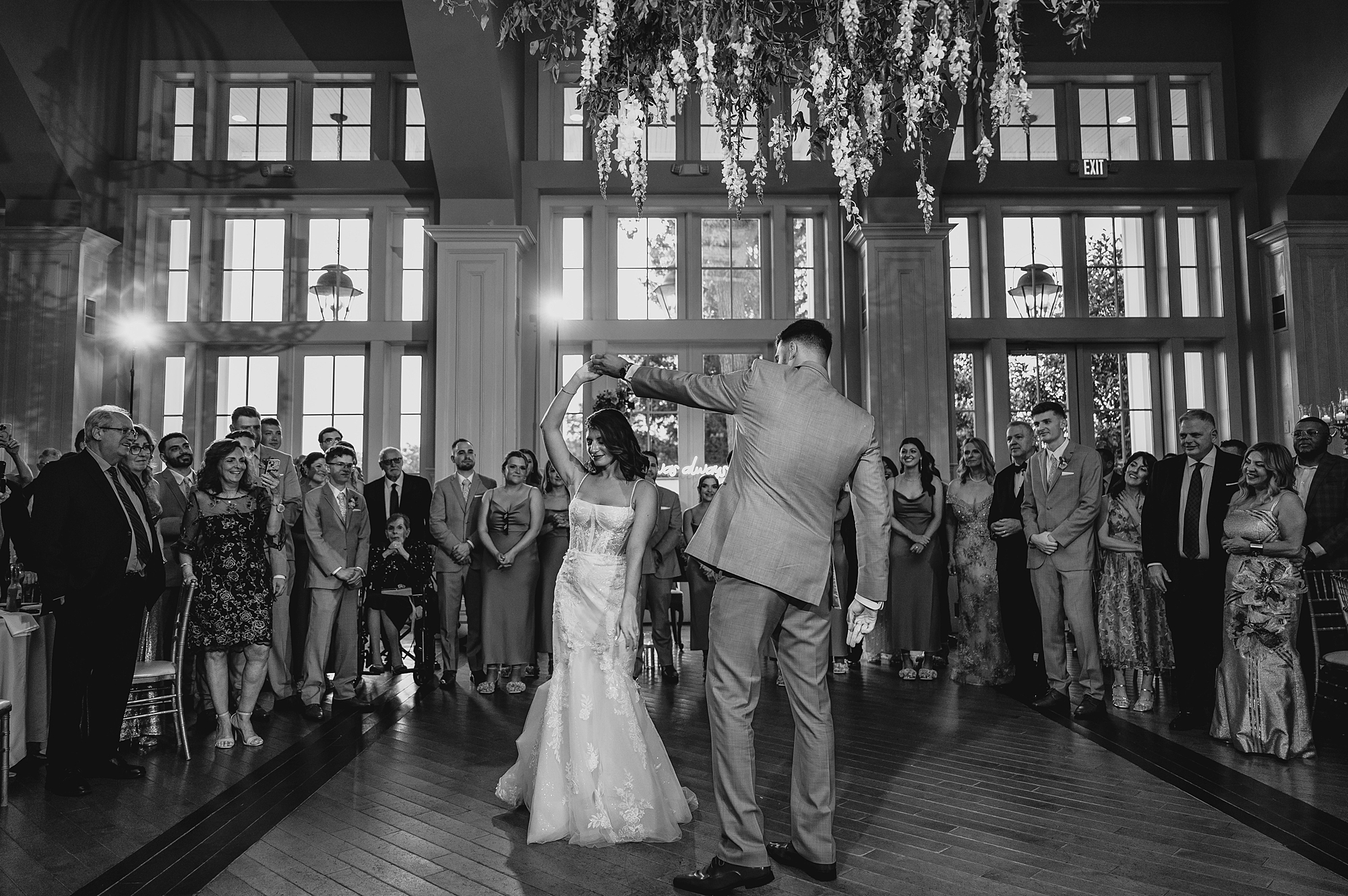 groom twirls bride on dance floor at the Ryland Inn