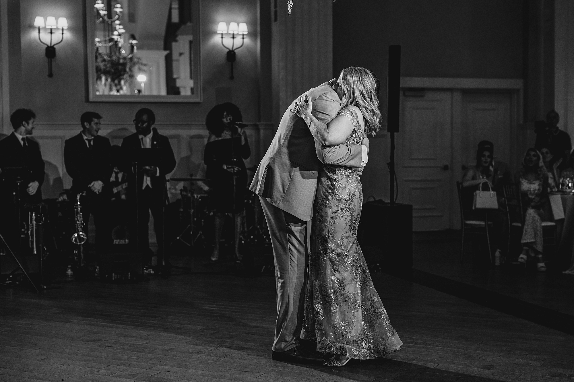 groom hugs mom on dance floor during reception at the Ryland Inn