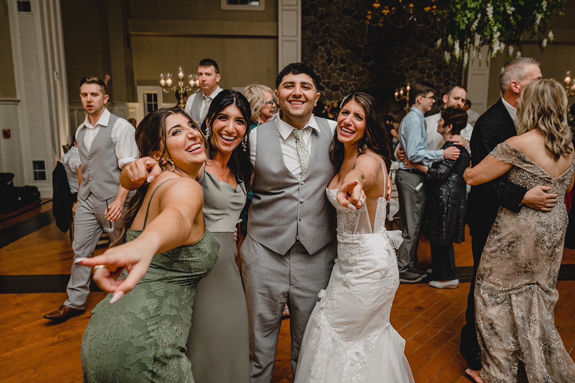 bride smiles with people on the dance floor