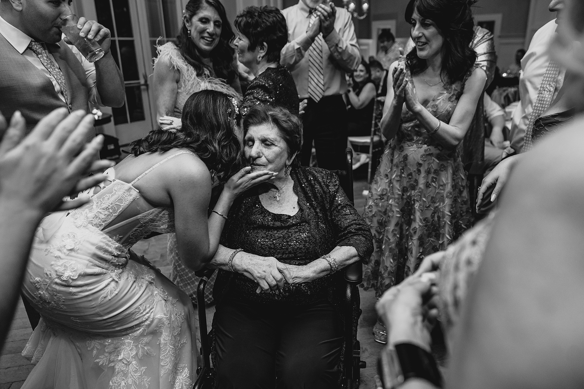 bride kisses grandmother in wheel chair