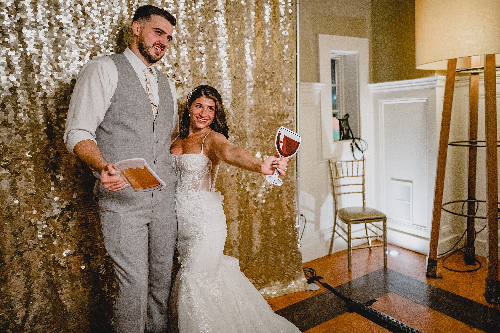 bride and groom pose in photo booth during NJ wedding reception