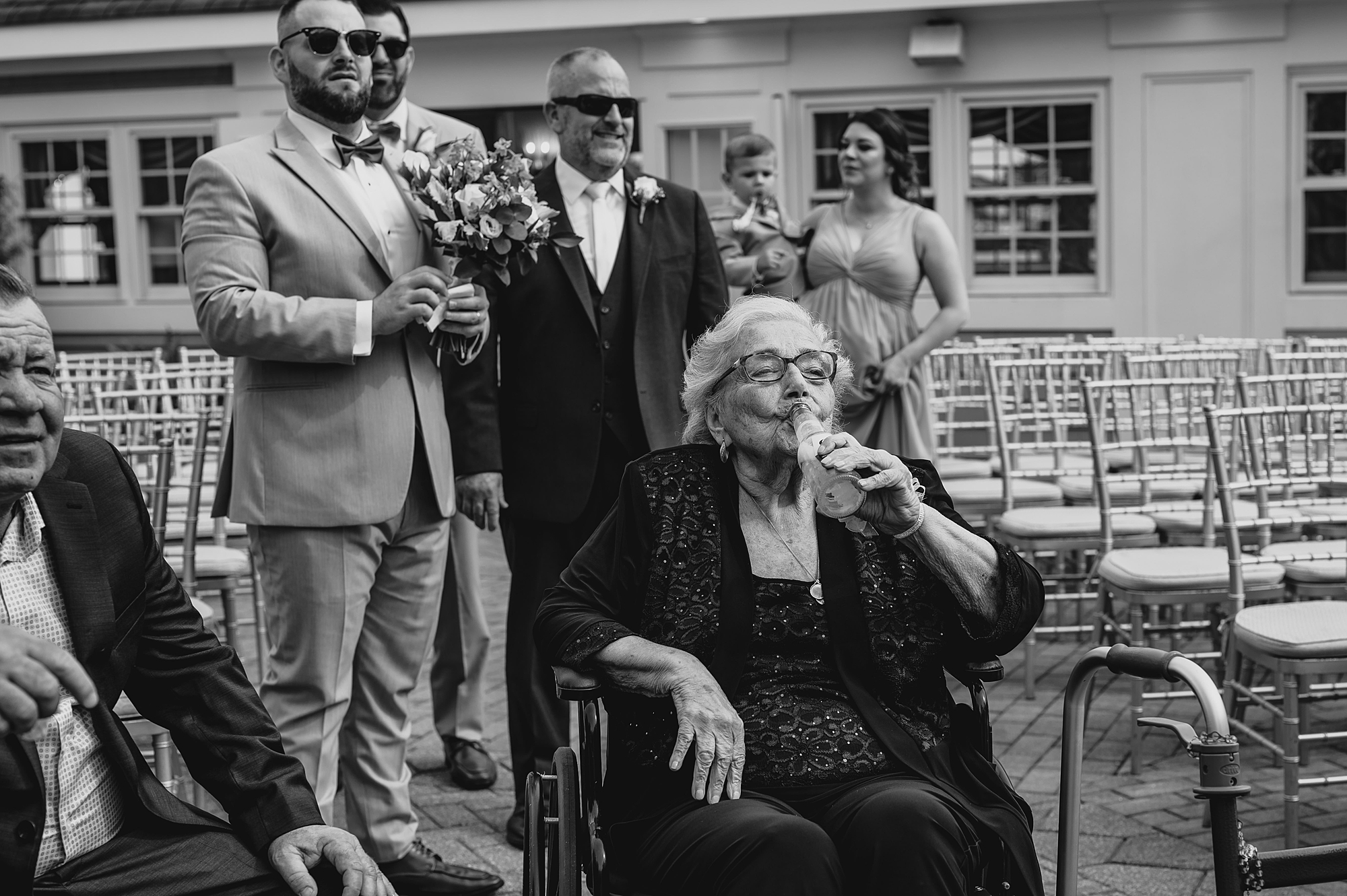 grandmother drinks water waiting for ceremony at Bridgeview Yacht Club