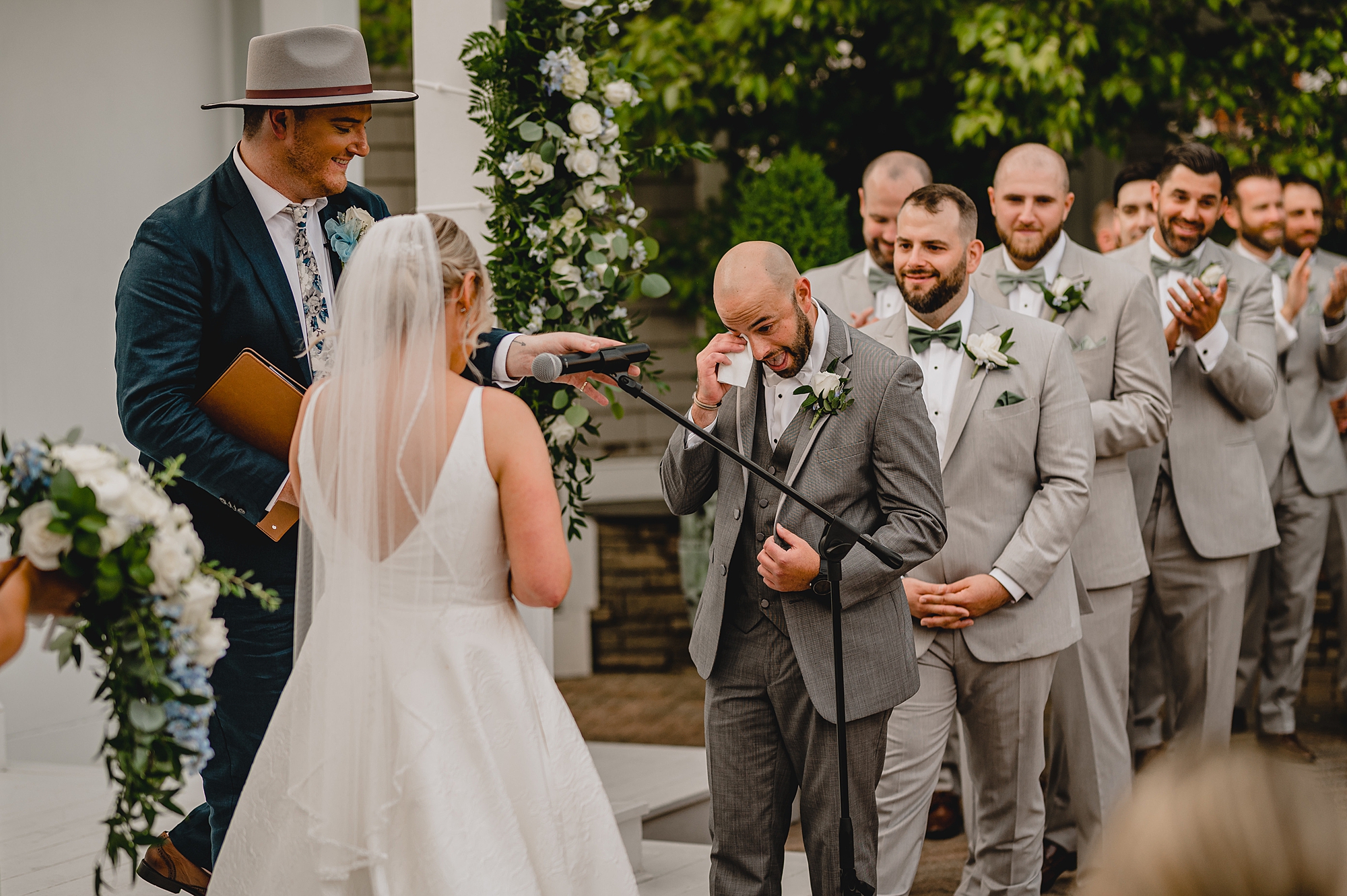 groom cries wiping eyes during wedding ceremony