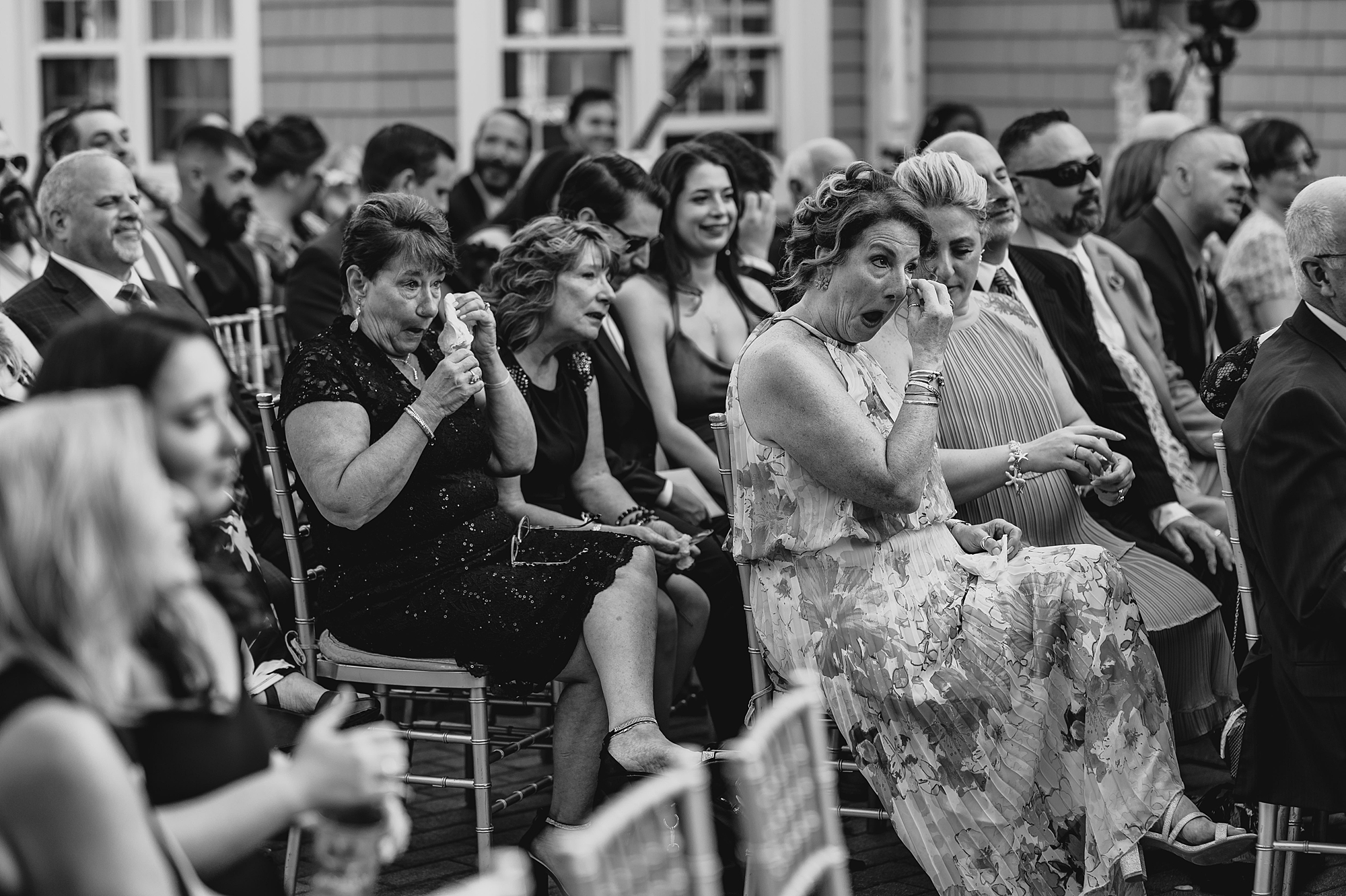 wedding guests wipe away tears during ceremony at Bridgeview Yacht Club