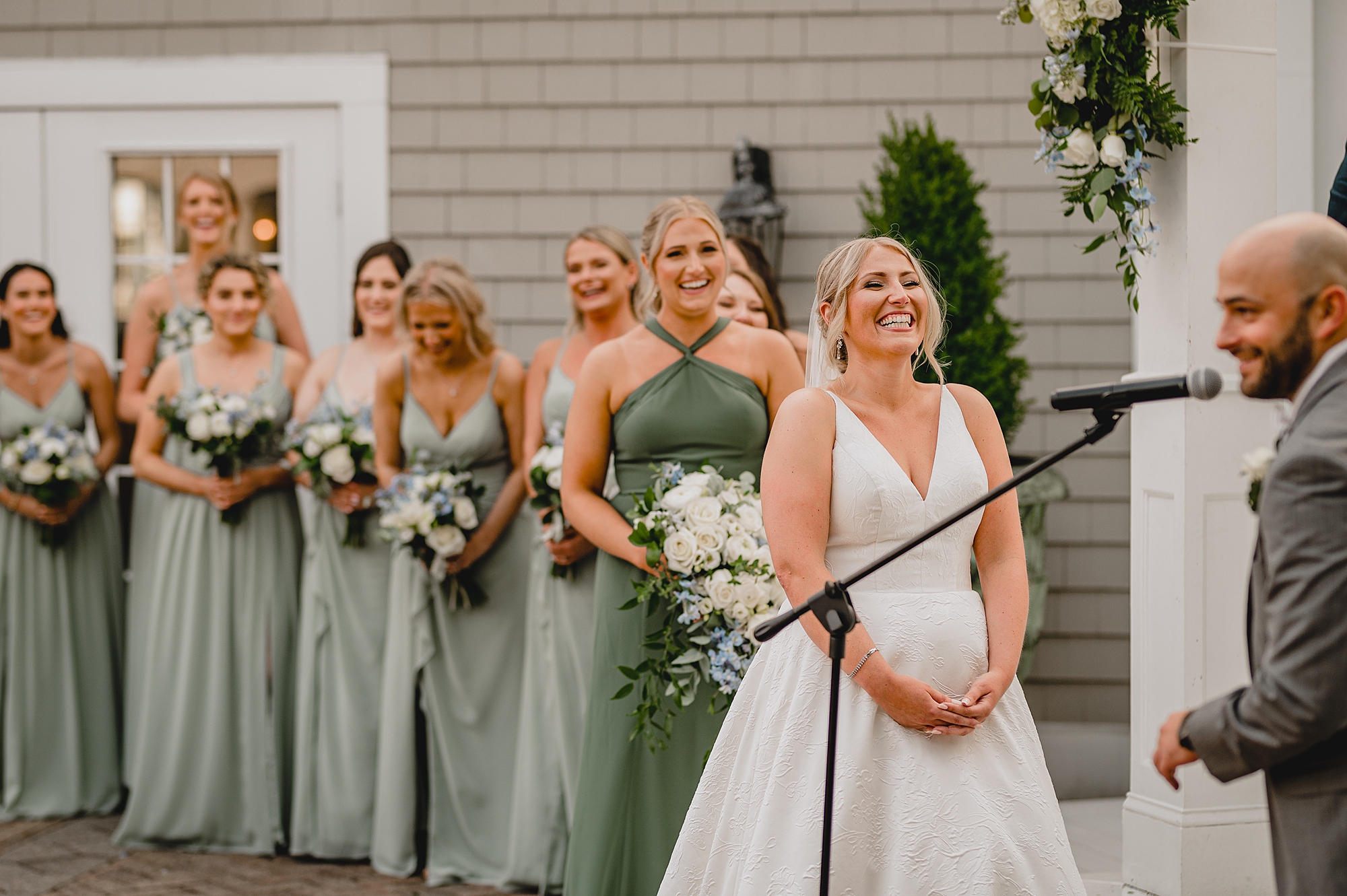 bride laughs listening to groom during wedding ceremony