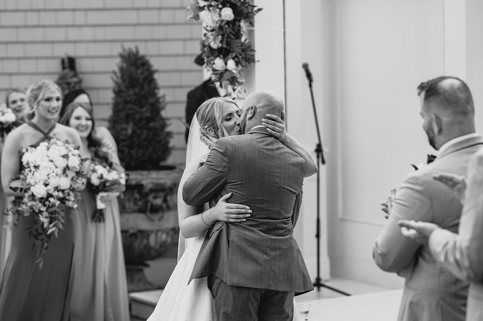 bride and groom kiss during wedding ceremony at Bridgeview Yacht Club