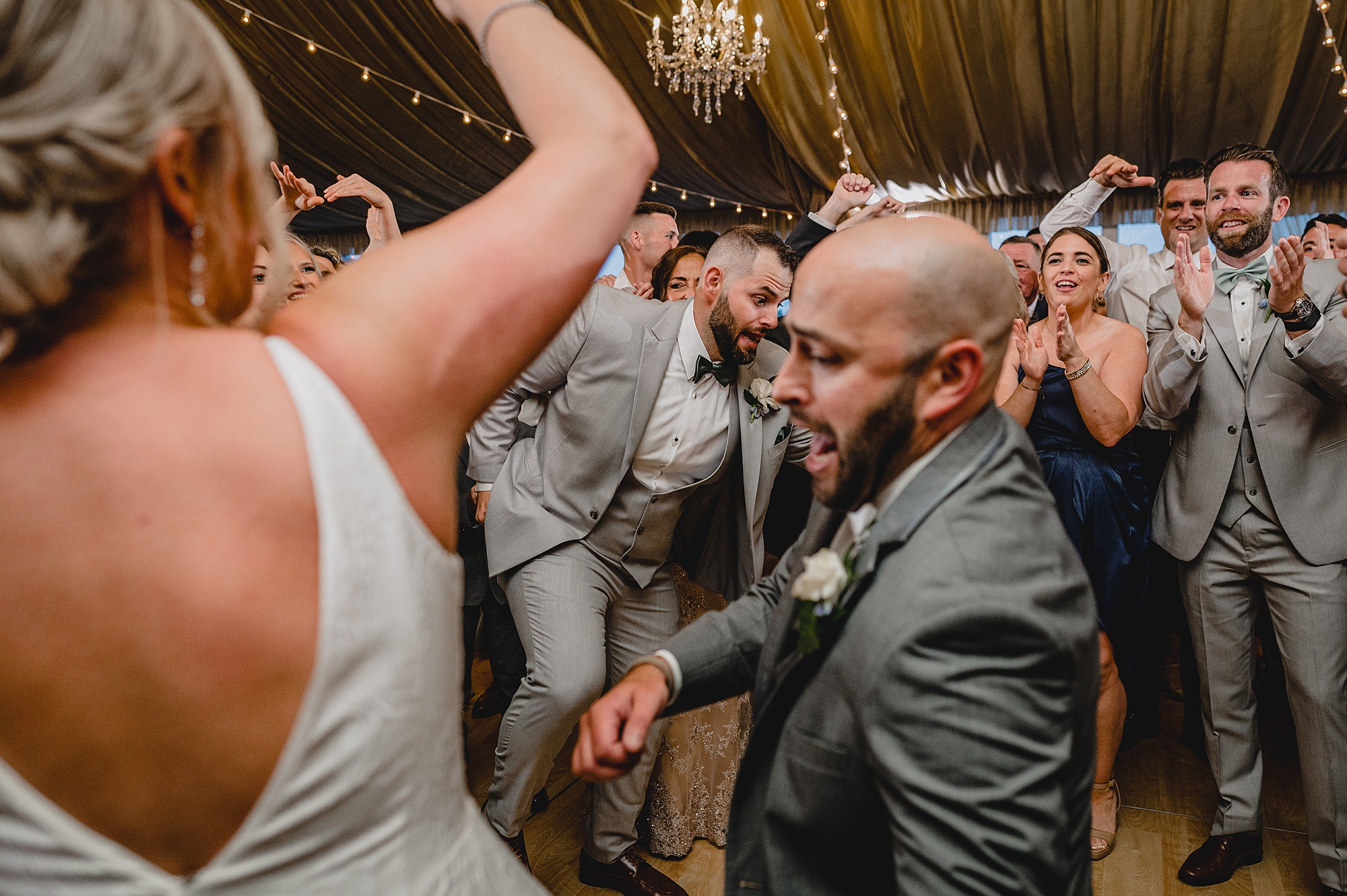 bride and groom dance with guests during wedding reception at Bridgeview Yacht Club