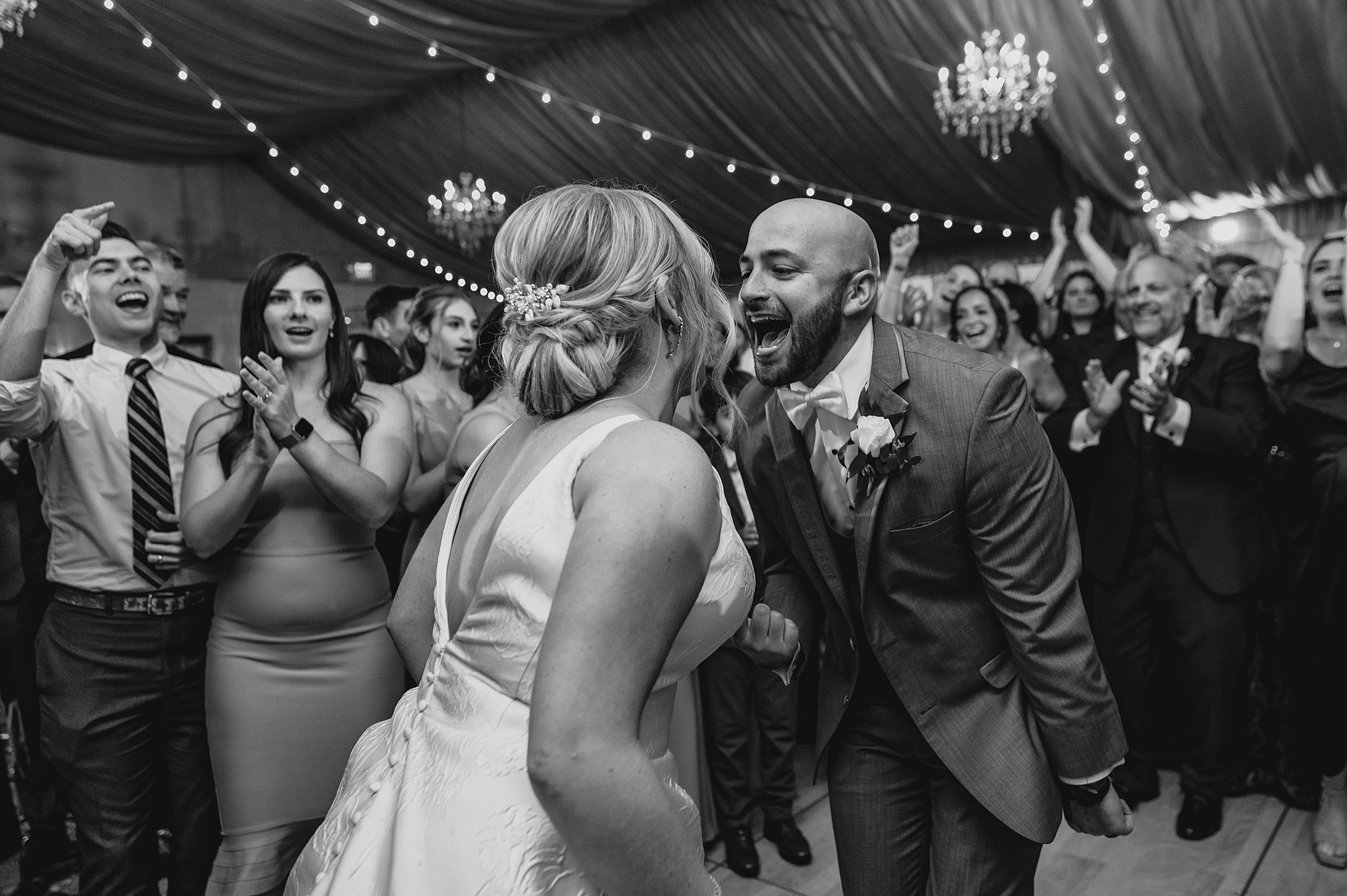 bride and groom dance with guests during wedding reception at Bridgeview Yacht Club