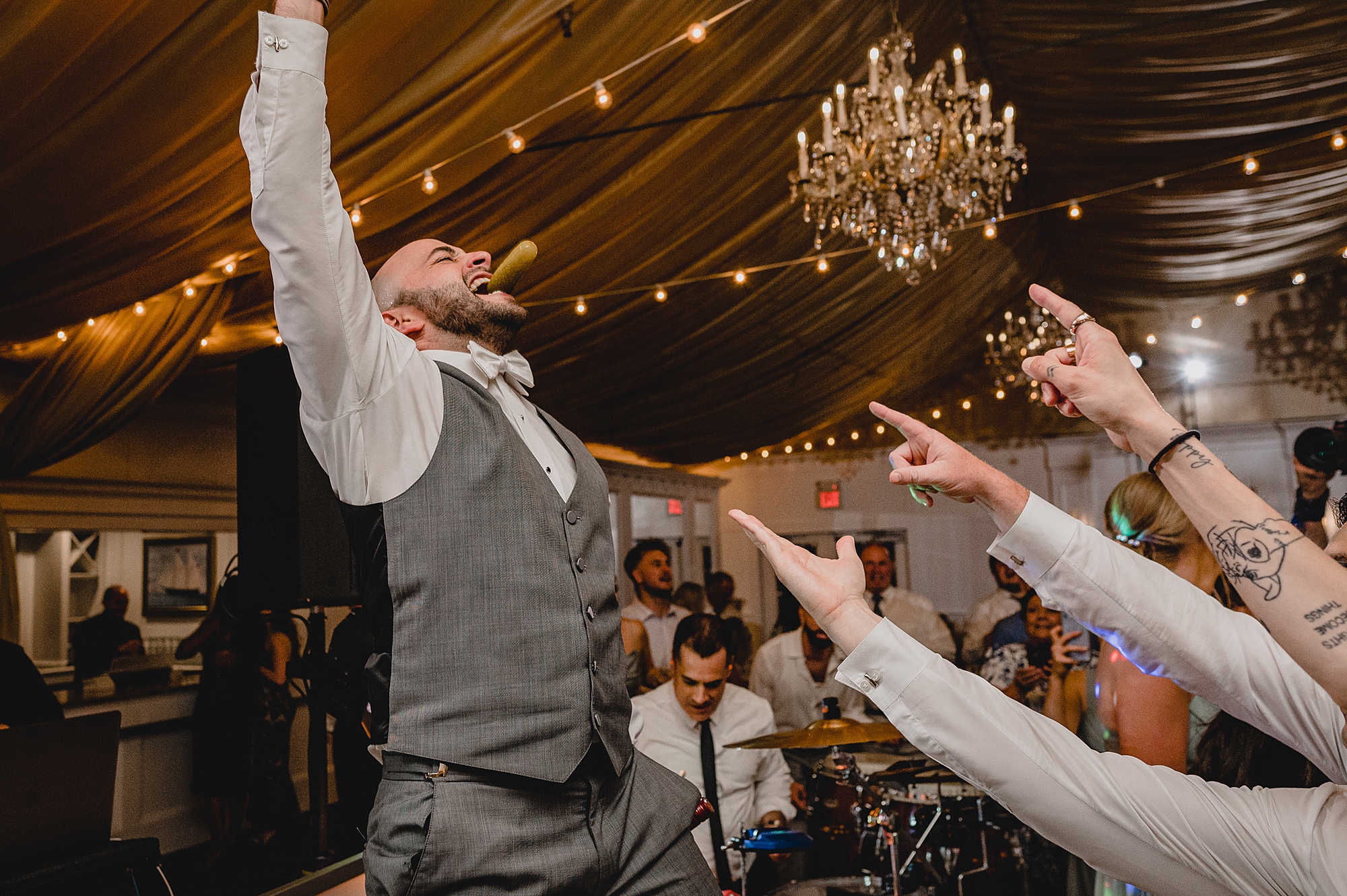 bride and groom dance with guests during wedding reception at Bridgeview Yacht Club
