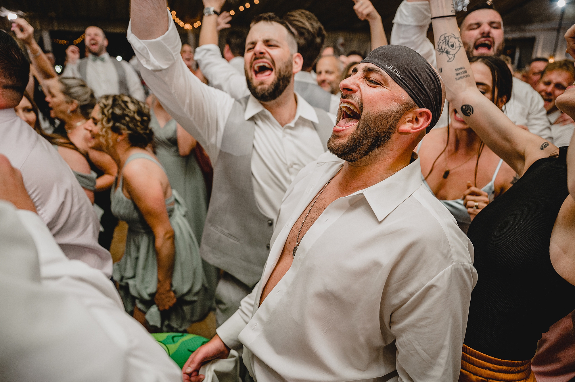 bride and groom dance with guests during wedding reception at Bridgeview Yacht Club