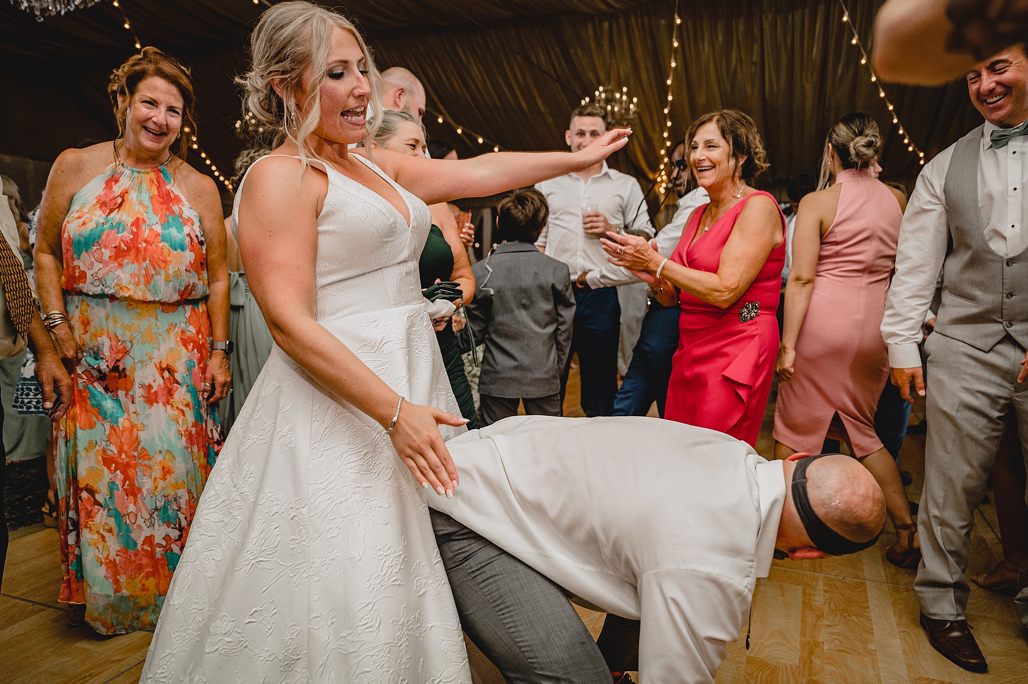 bride and groom dance with guests during wedding reception at Bridgeview Yacht Club