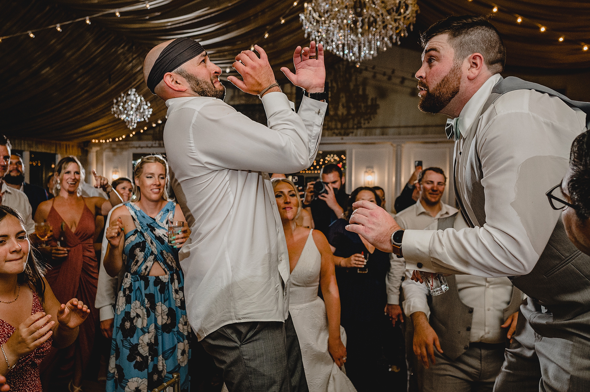 bride and groom dance with guests during wedding reception at Bridgeview Yacht Club