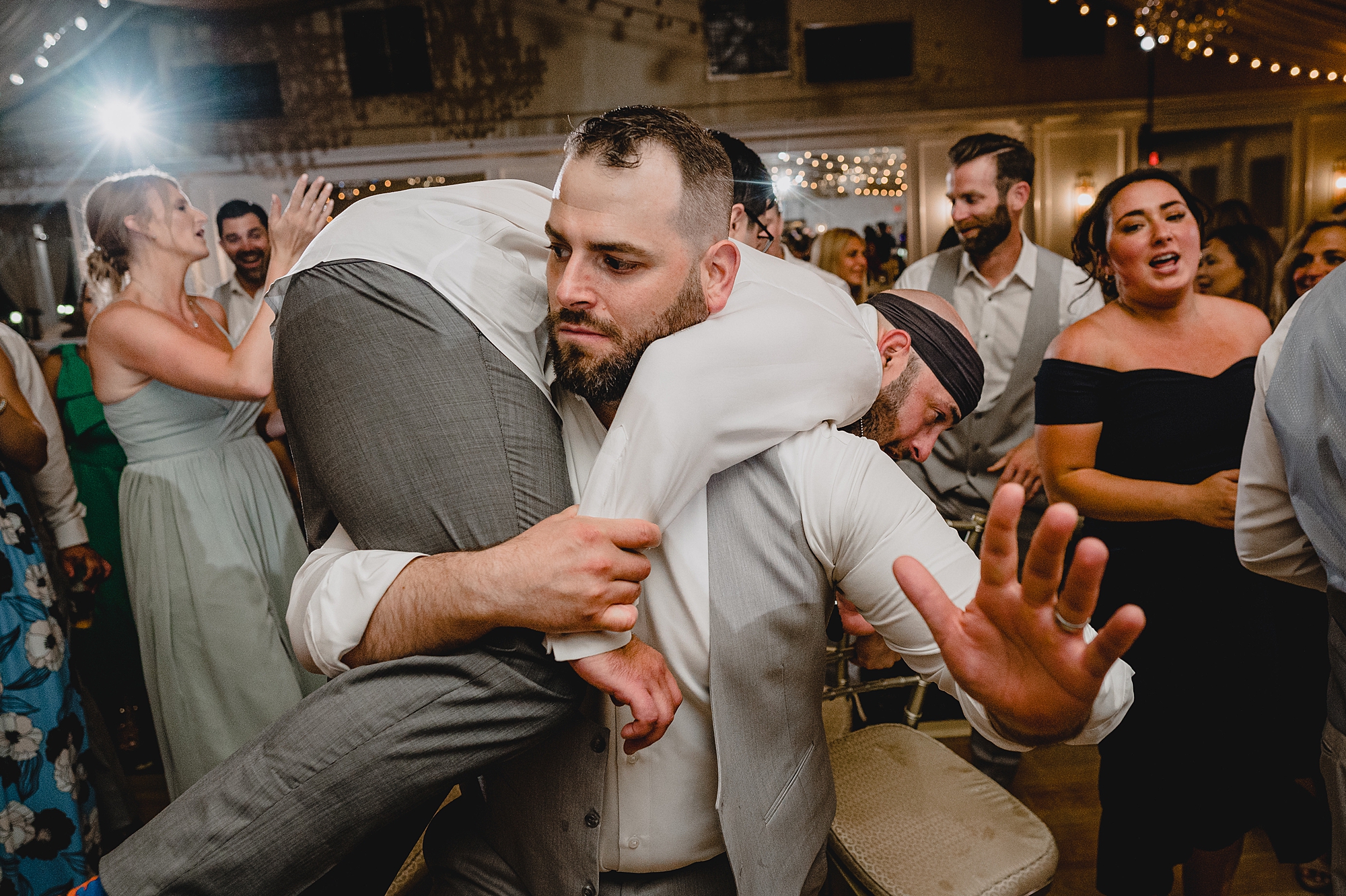 bride and groom dance with guests during wedding reception at Bridgeview Yacht Club
