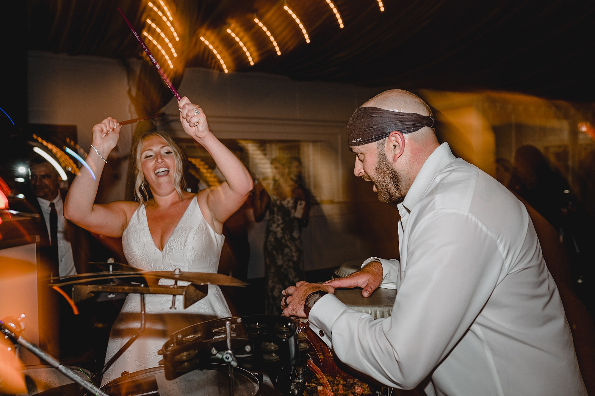 couple plays instruments during reception