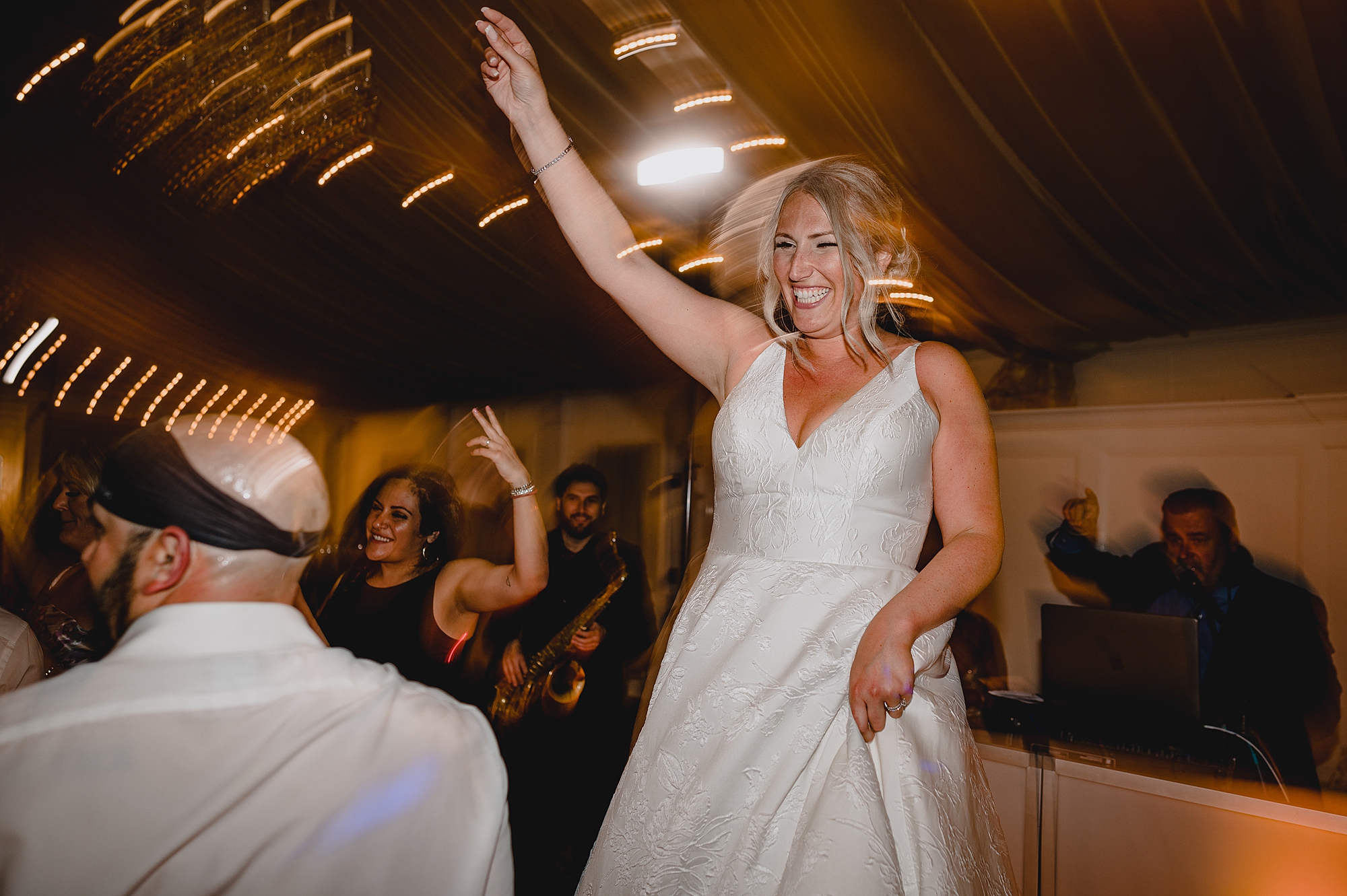 bride and groom dance with guests during wedding reception at Bridgeview Yacht Club