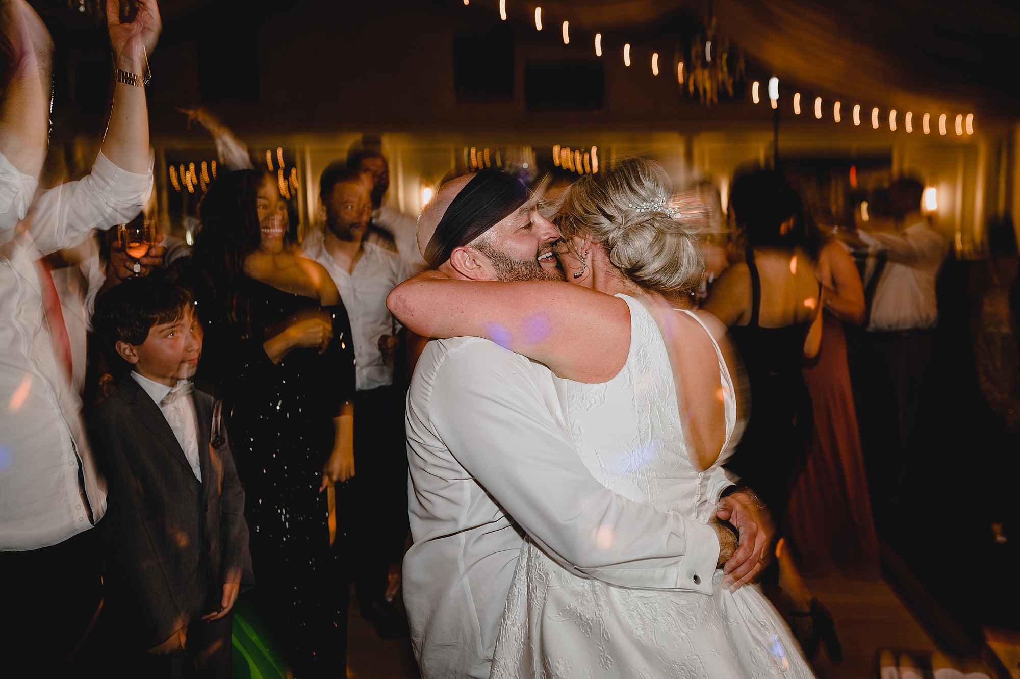bride and groom dance with guests during wedding reception at Bridgeview Yacht Club