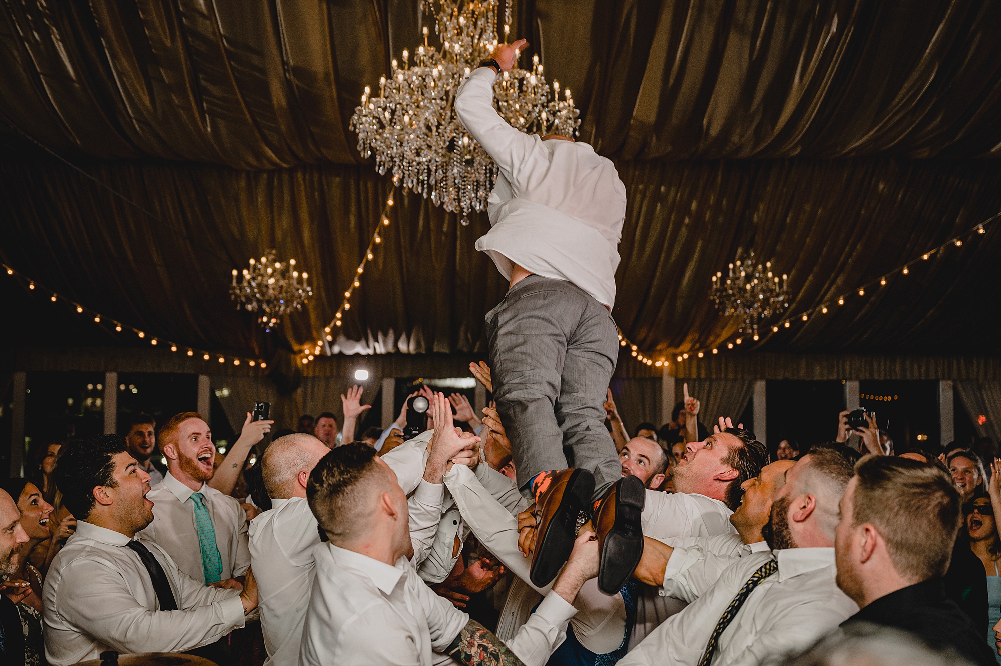 bride and groom dance with guests during wedding reception at Bridgeview Yacht Club