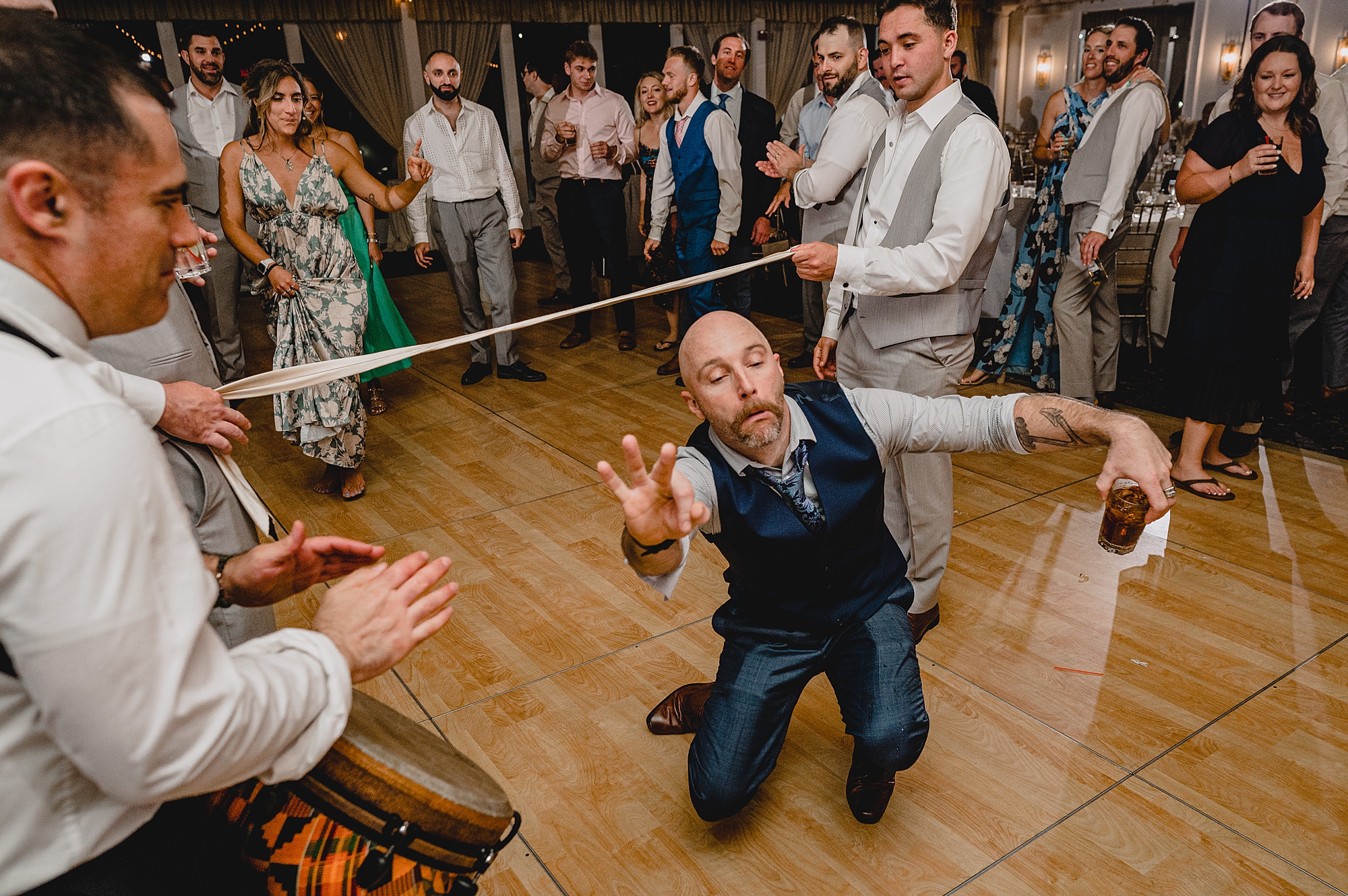 man does limbo during Island Park wedding reception