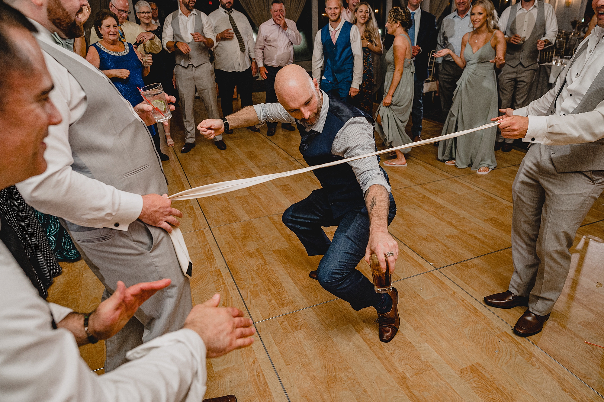 man does limbo during Island Park wedding reception