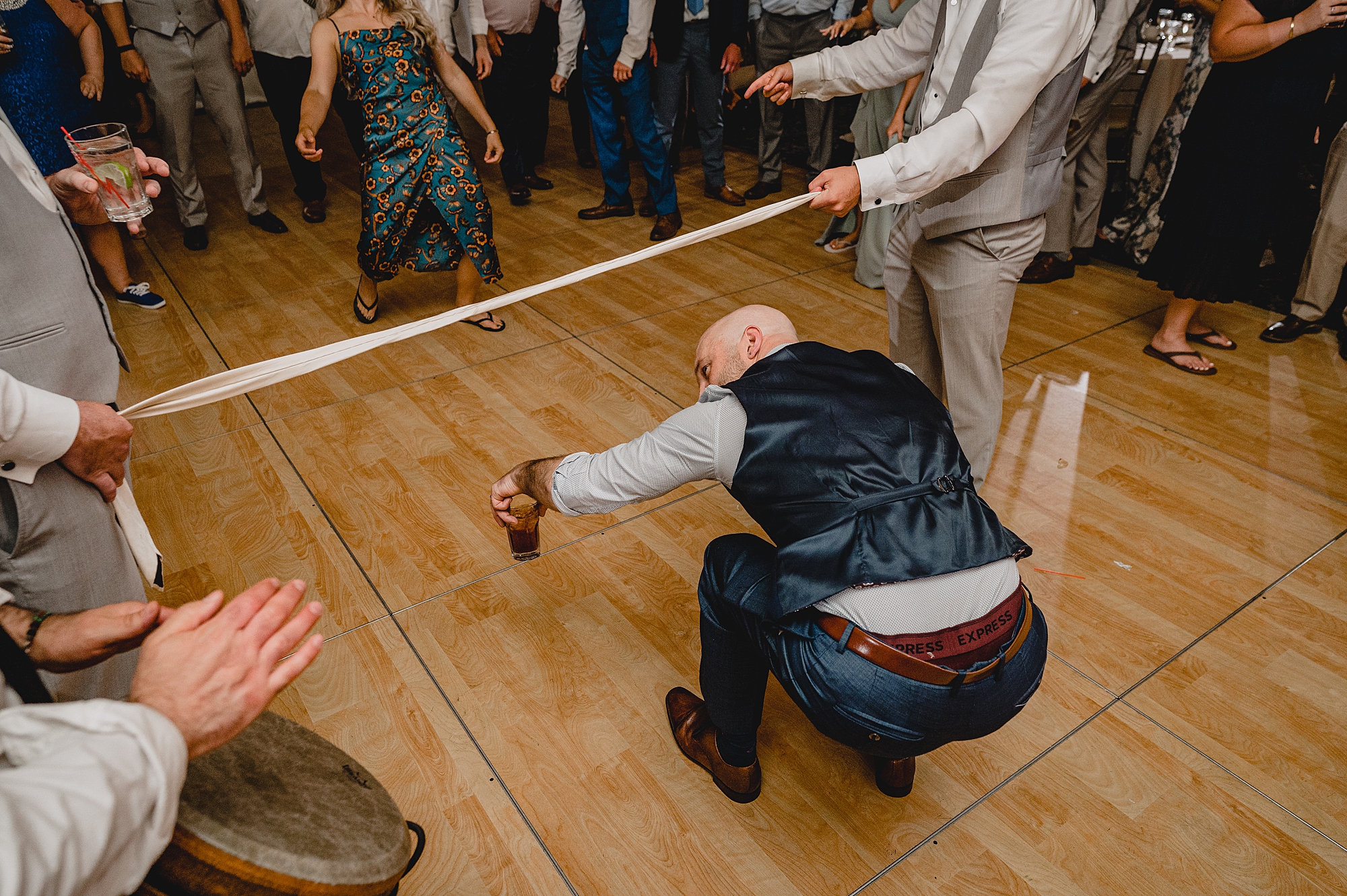 man does limbo during Island Park wedding reception