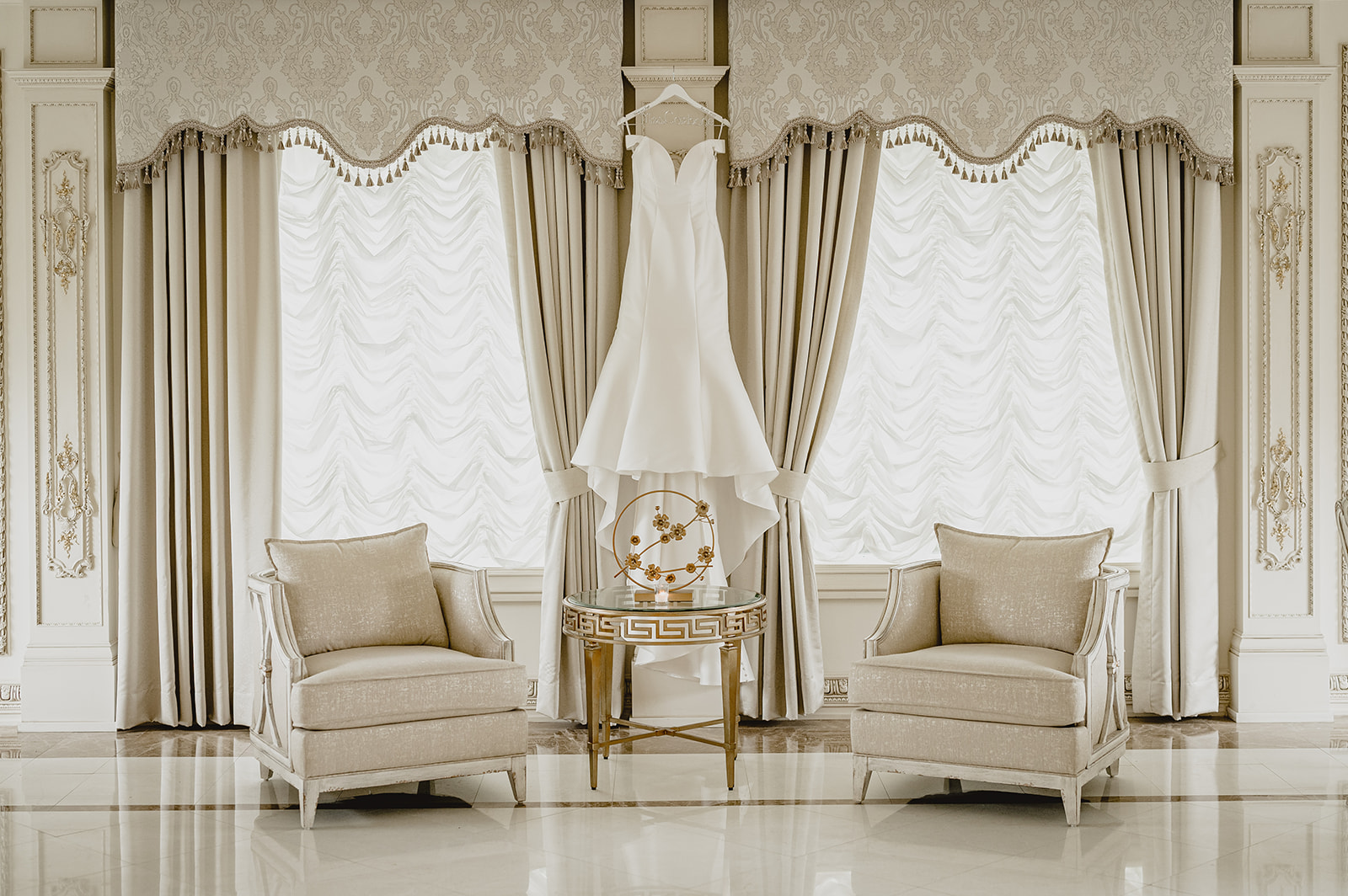 wedding dress hangs above seating area inside the Venetian