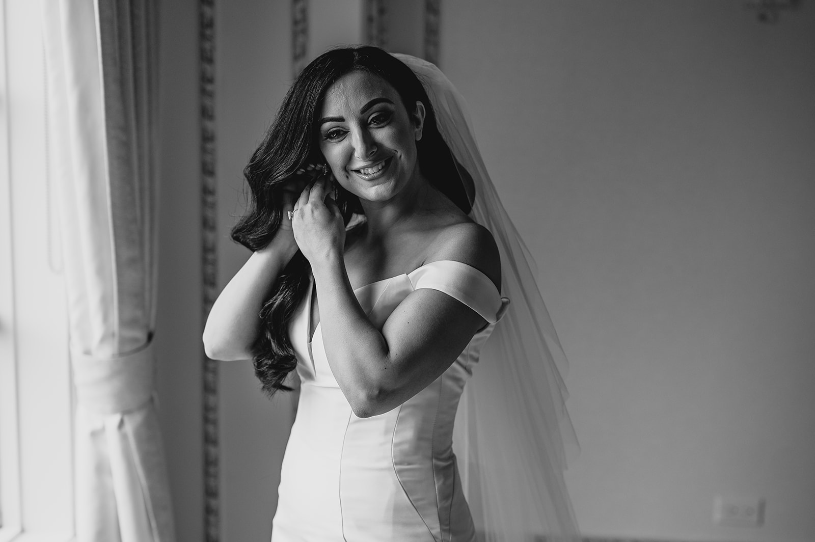 bride smiles adjusting earring in suite at the Venetian 