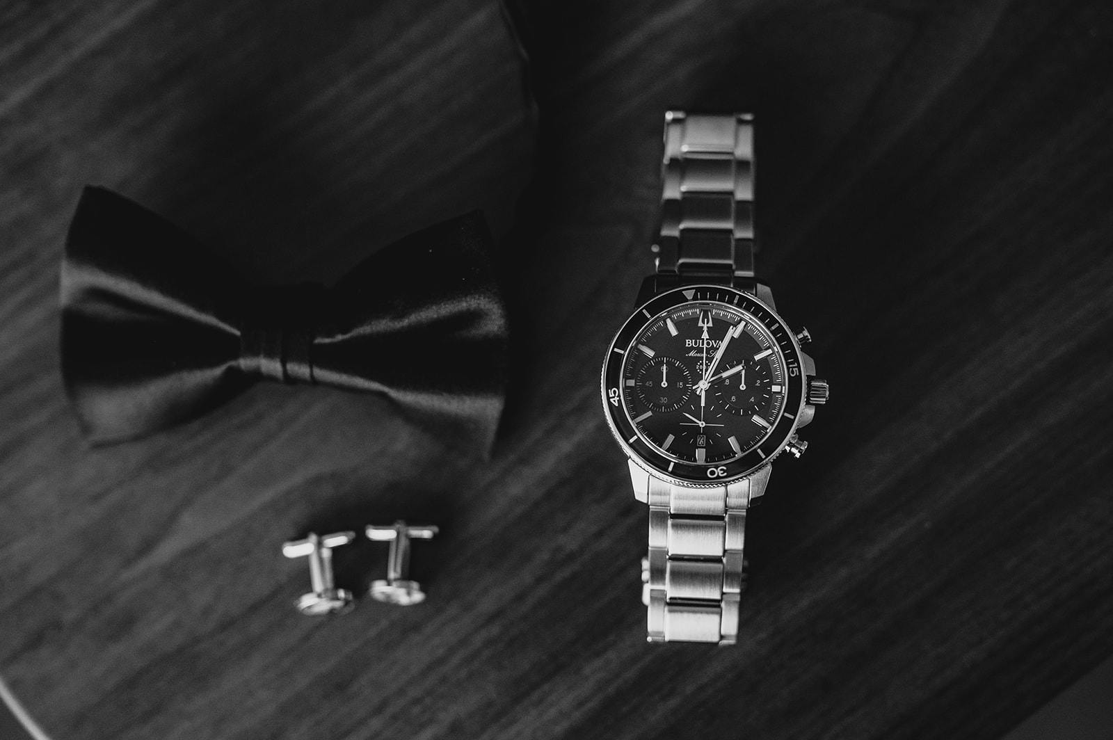 groom's watch and cufflinks with black bow tie