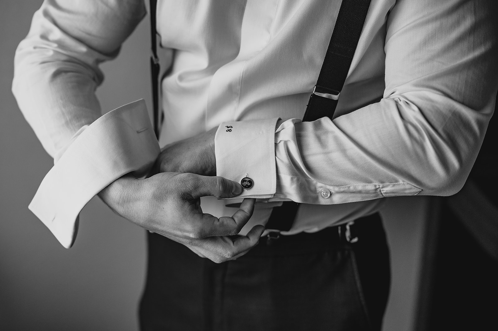 groom adjusts cufflinks during prep for wedding at the Venetian 