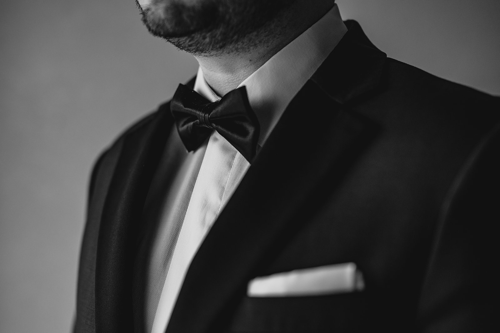 close up of black bow tie on tux for groom