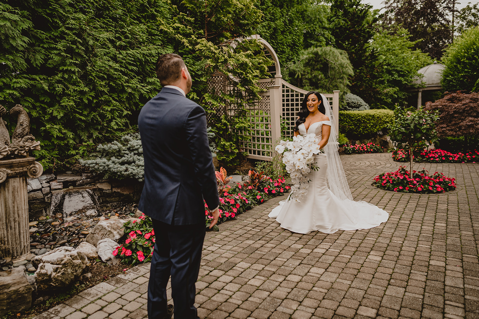 groom turns to look at bride in gardens of the Venetian