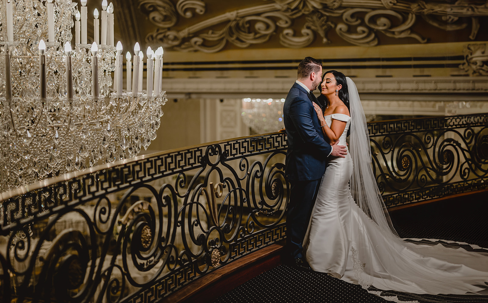 newlyweds kiss inside the Venetian on balcony by railing 
