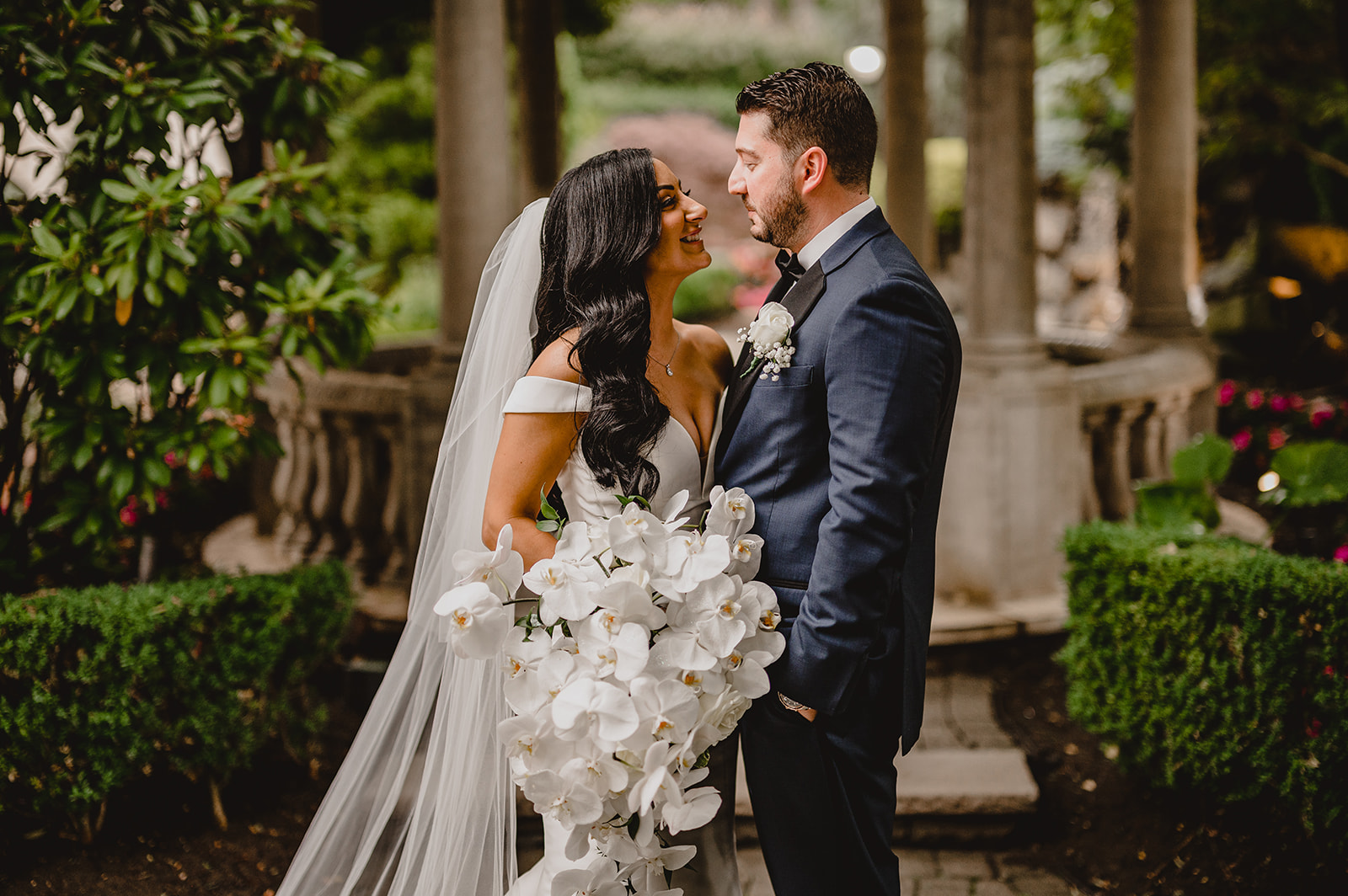 bride and groom smile in front of gazebo at the Venetian