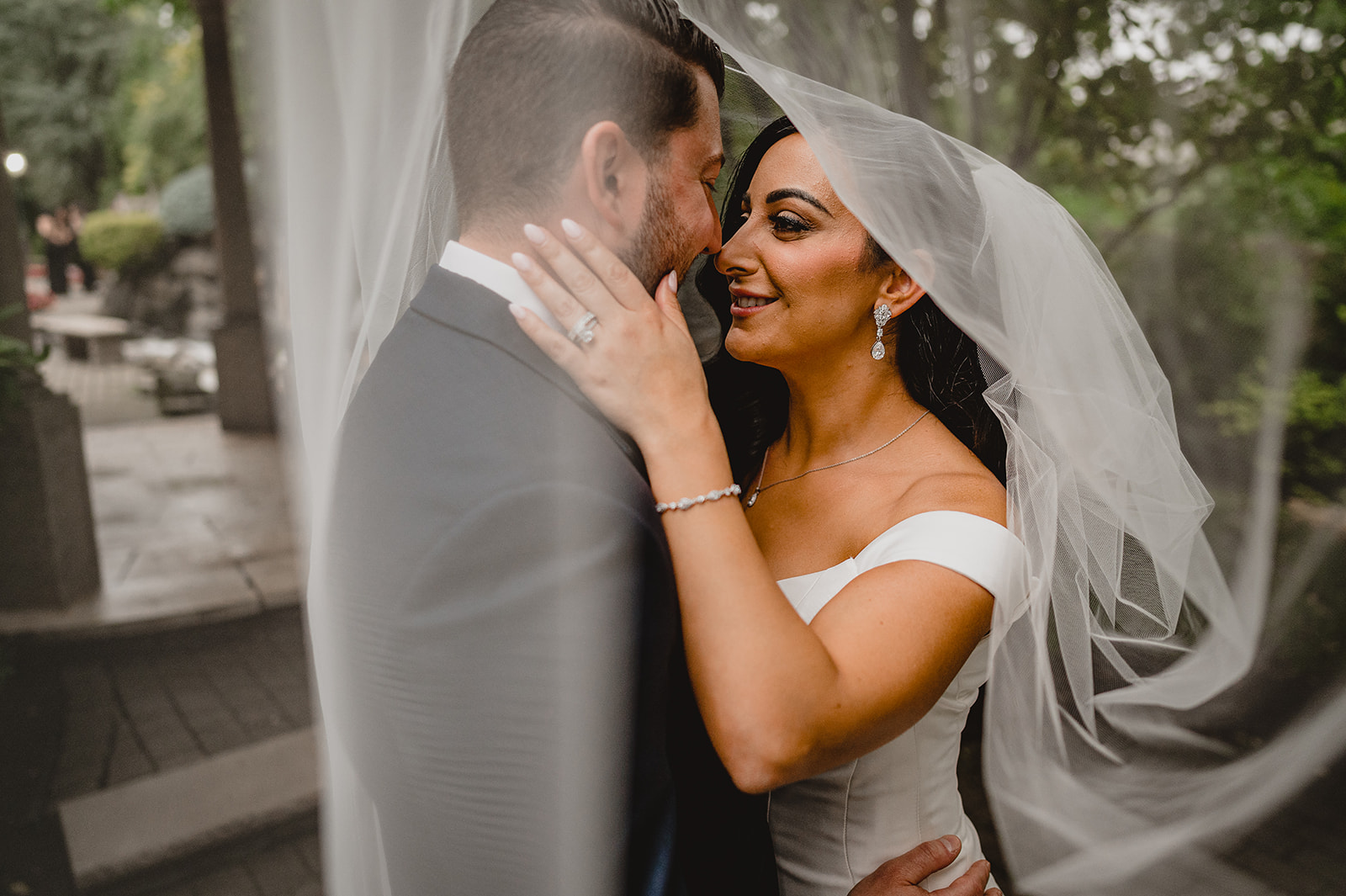 bride and groom smile under bride's veil at the Venetian