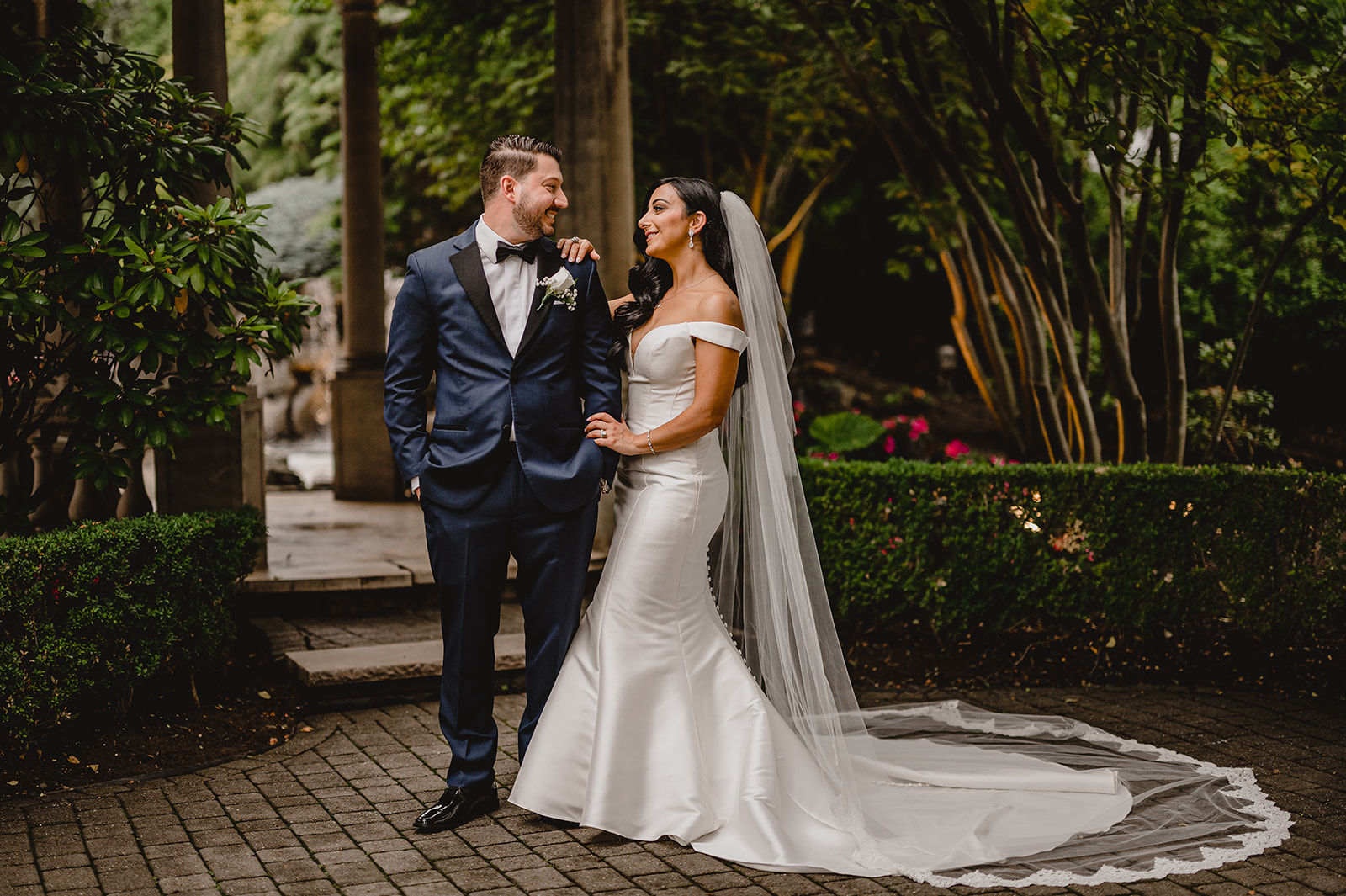 bride and groom stand together in the gardens of the Venetian