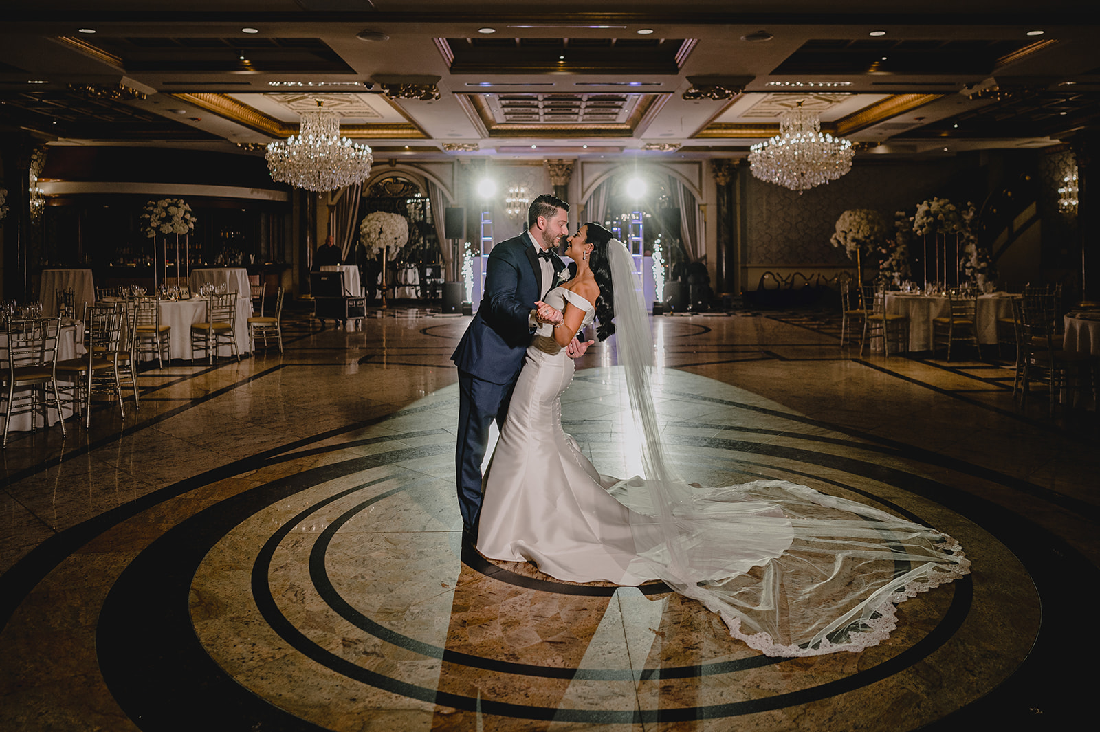 bride and groom kiss backlit in the ballroom at the Venetian